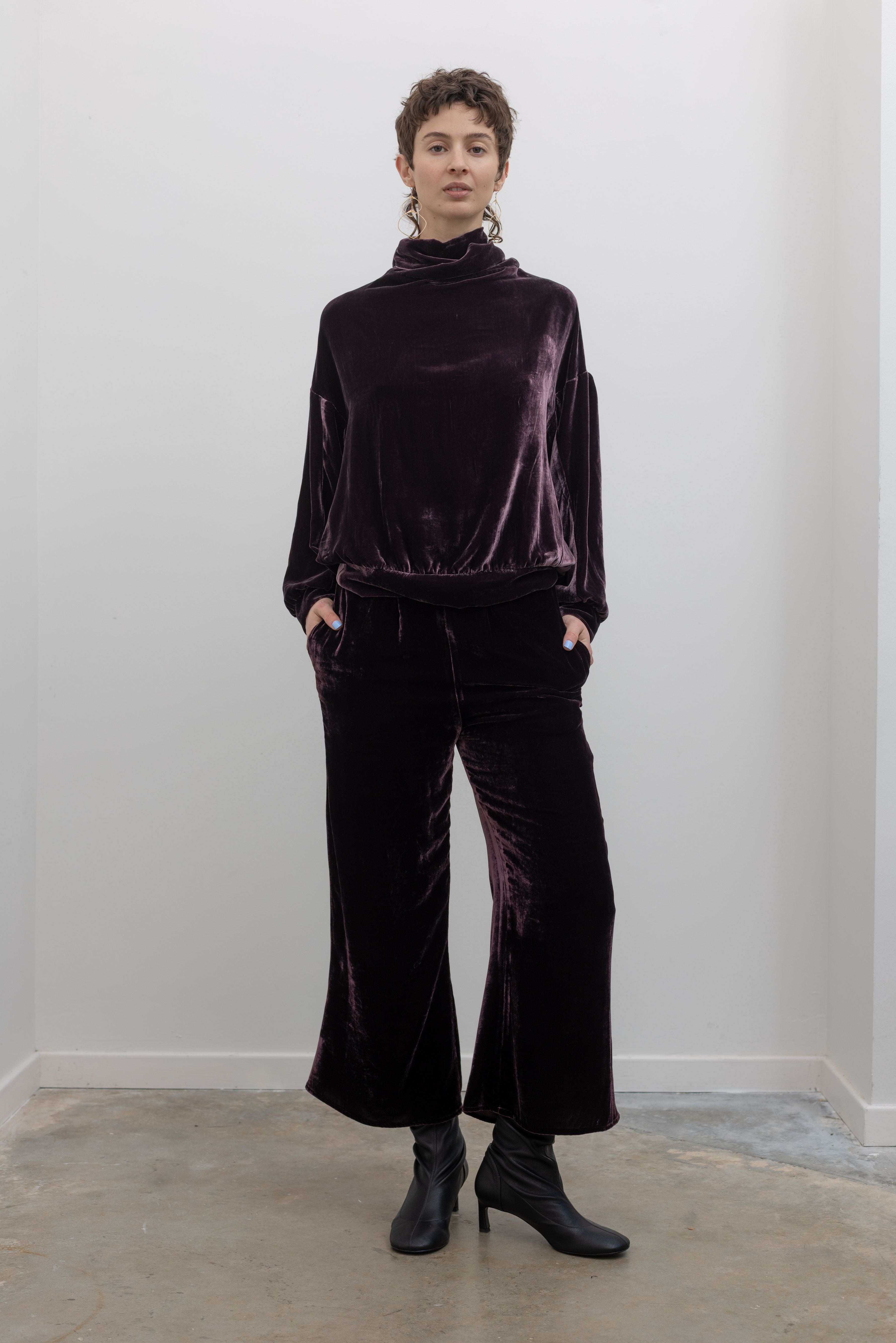 Person wearing a dark purple velvet outfit at alas eius. fall fashion