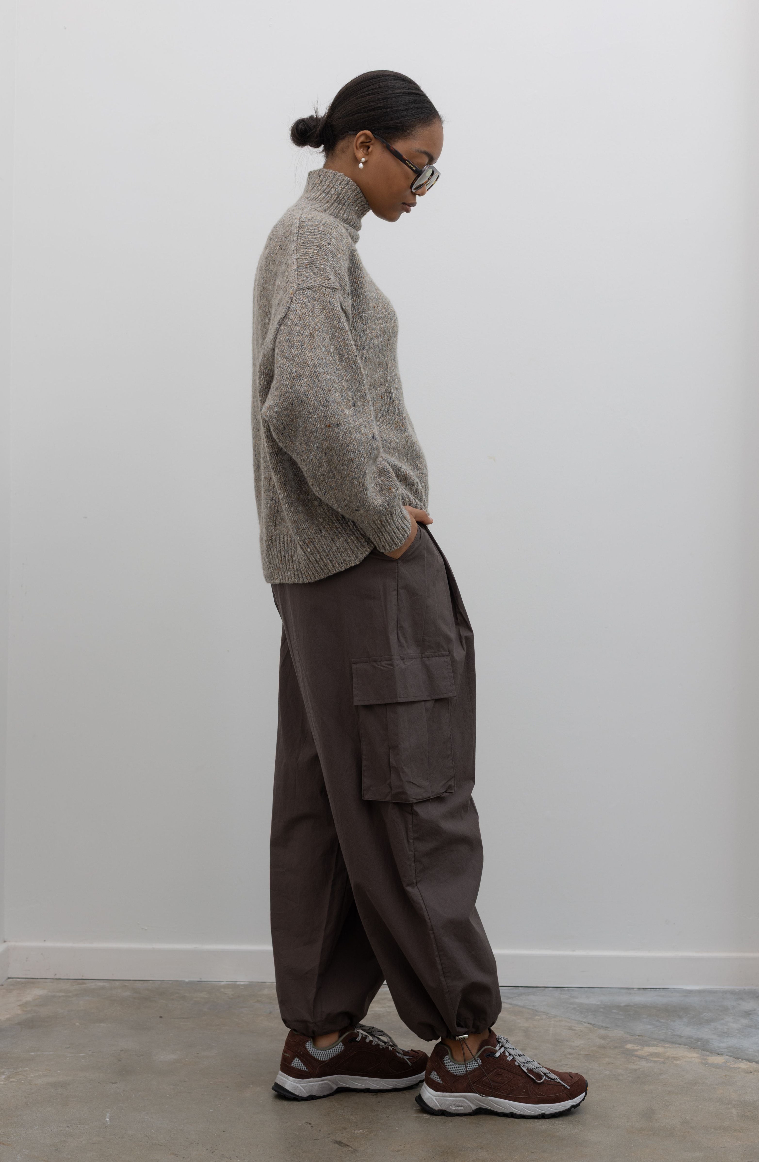 Alas Eius brown cotton cargo pants, side view, with love classic sneakers and Wijnants sweater 