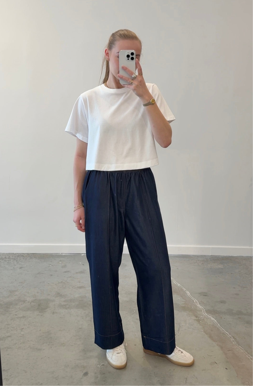 Alas Eius dark wash tailored pull-on pant, styled with white top, front view