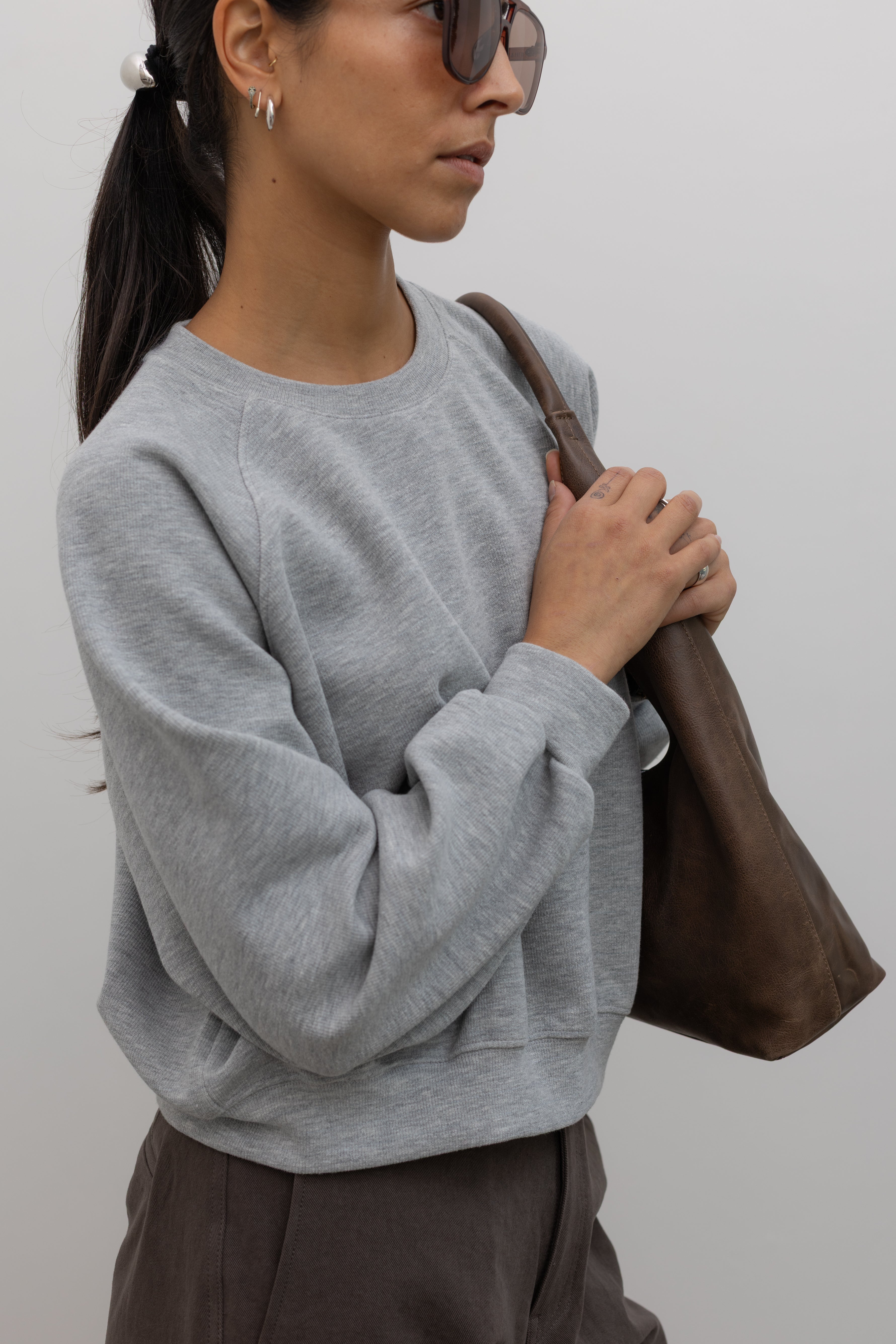 Heather gray raglan sleeve sweatshirt, angled view