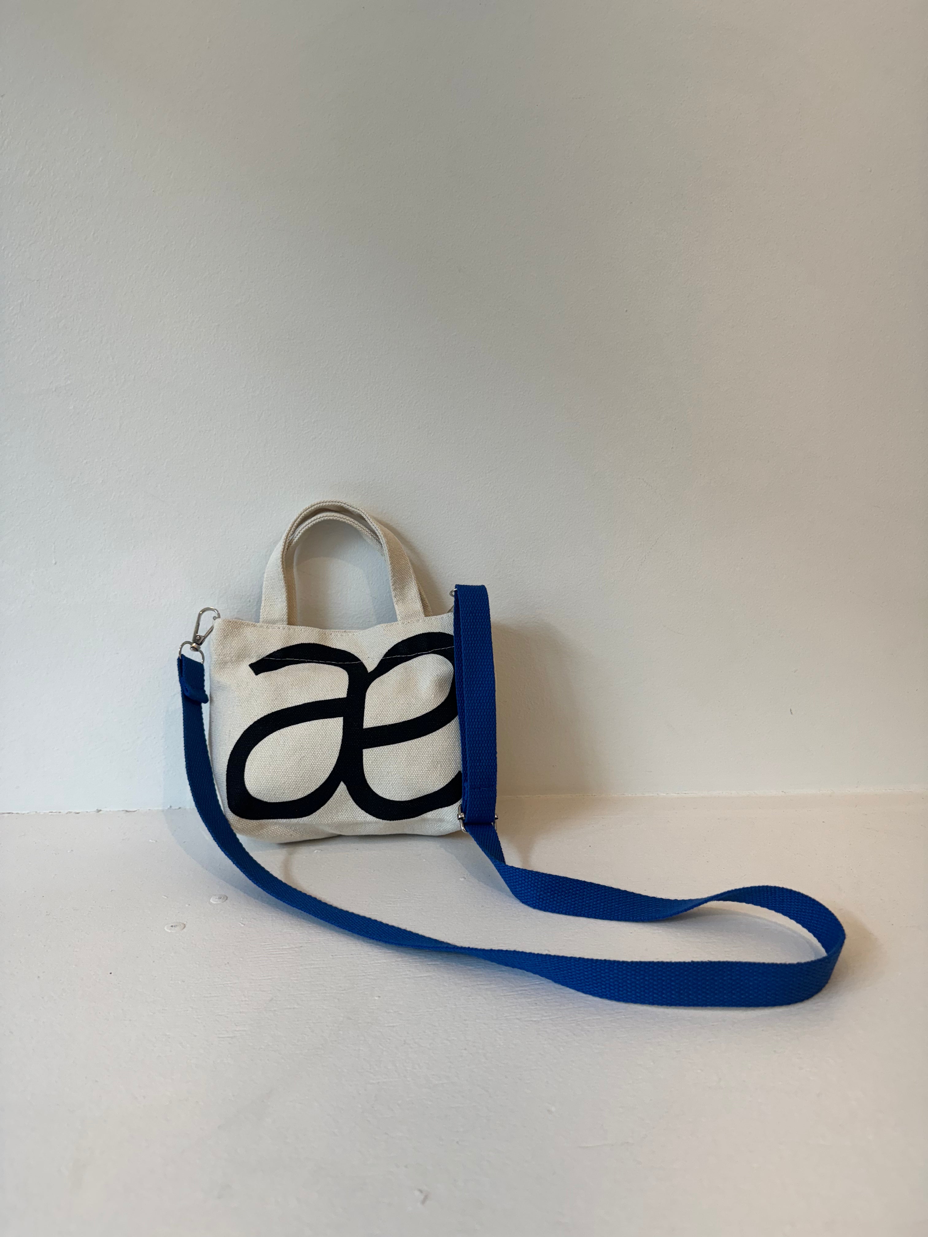 Alas Eius mini cotton tote bag with removable cobalt blue strap, flat lay