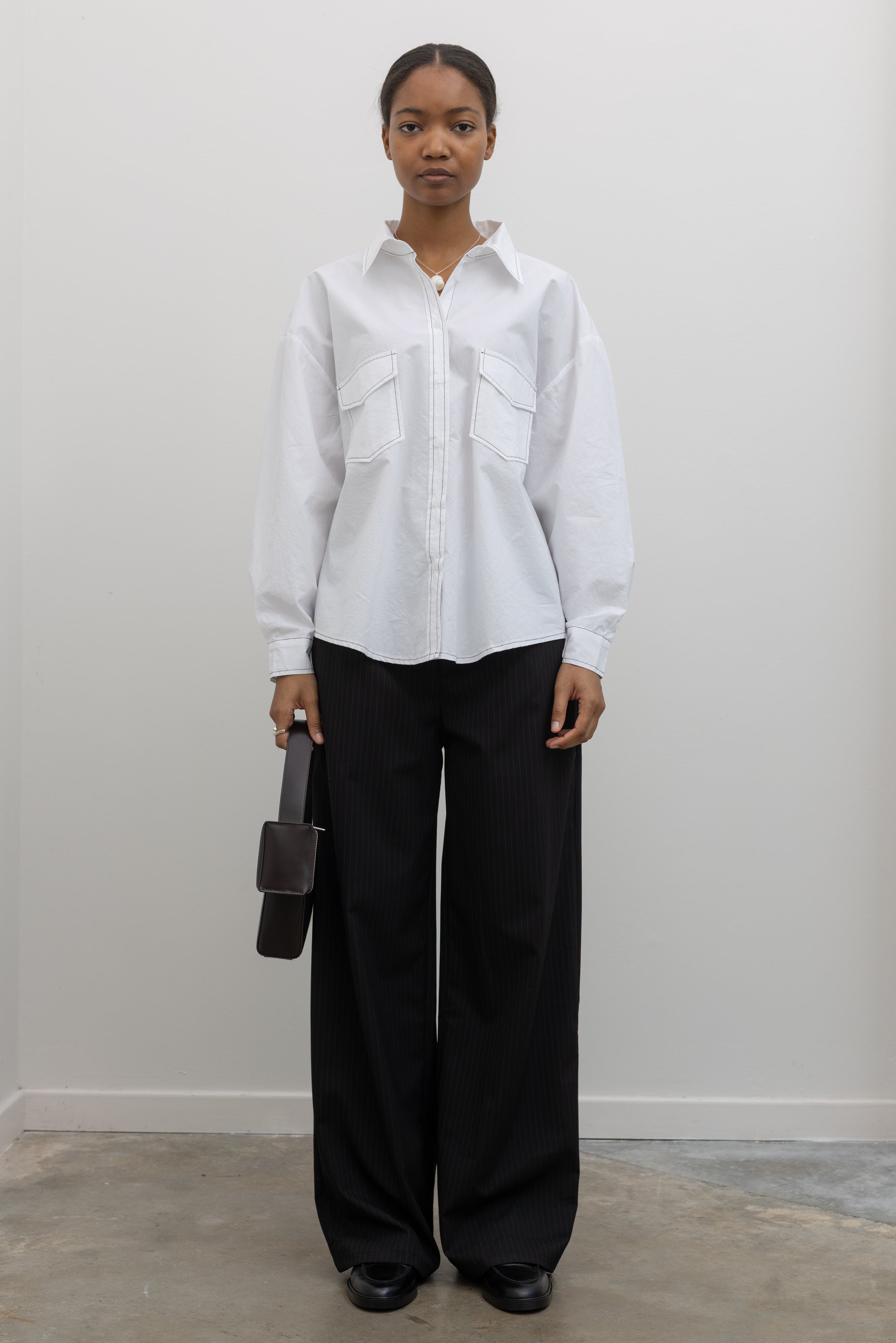 Alas Eius white contrast stitch oversized button down shirt styled with black pants