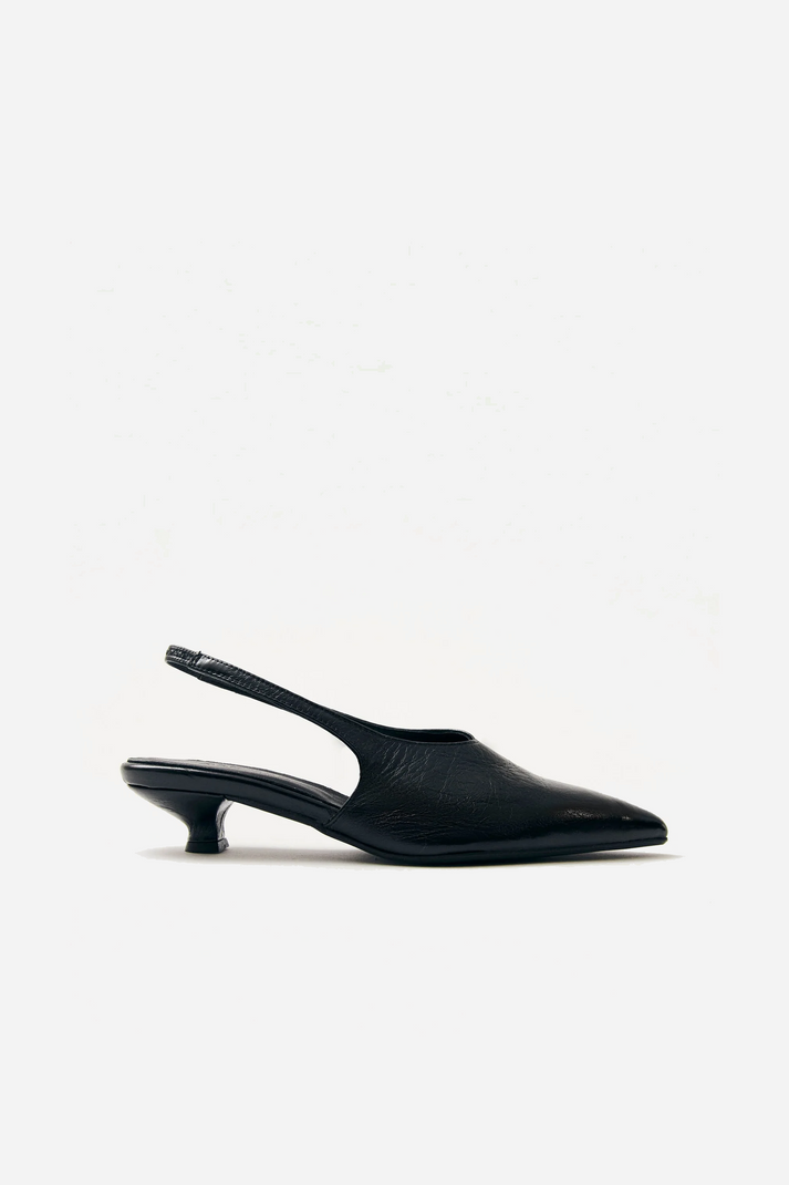 Alohas minimalist black slingback heels featuring elasticated strap and elongated pointed vamp for elegant silhouette at Alas Eius