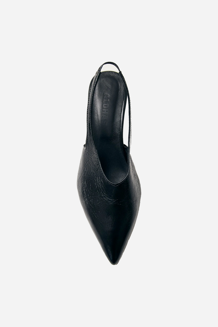 Alohas minimalist black slingback heels featuring elasticated strap and elongated pointed vamp for elegant silhouette at Alas Eius 
