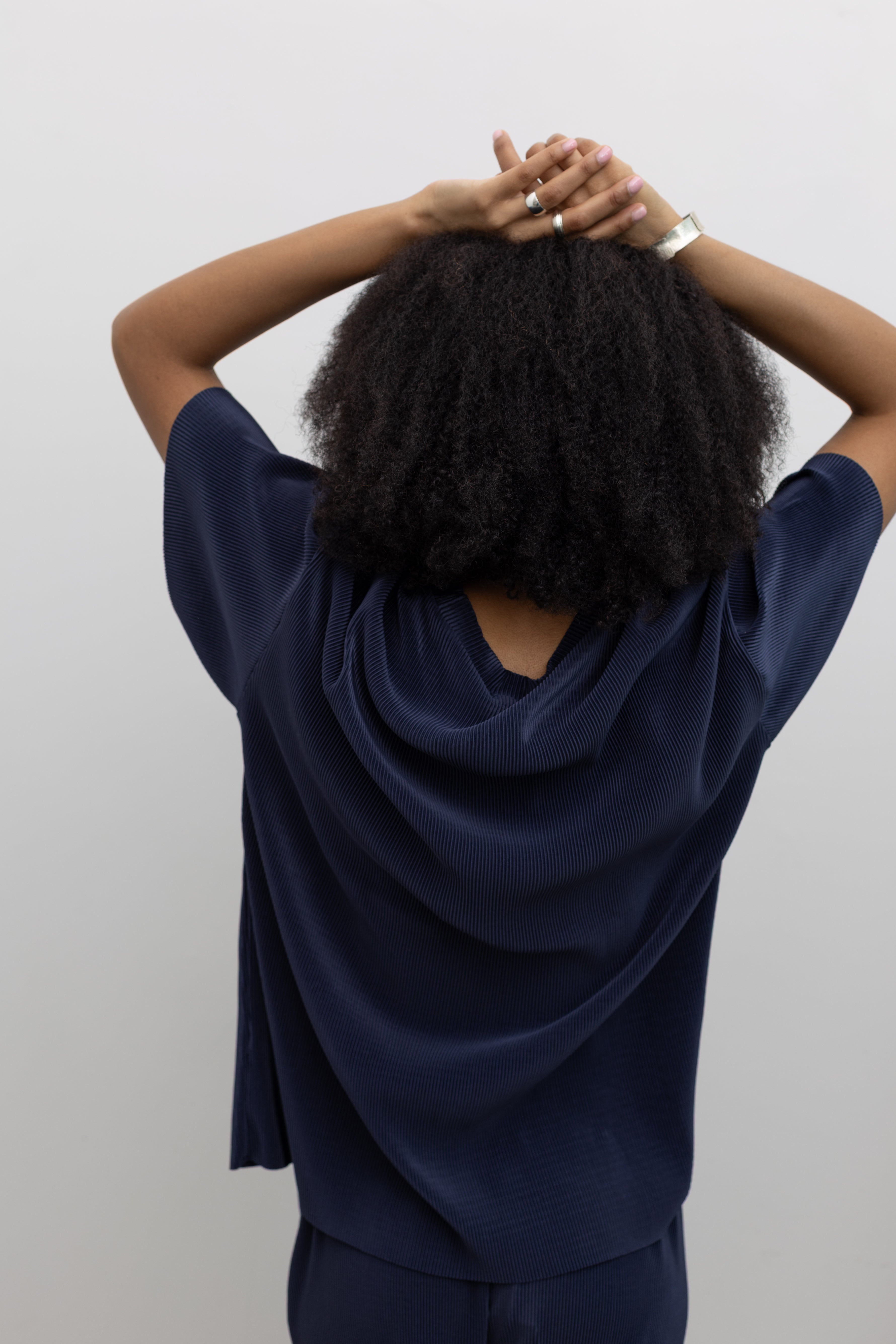 Collective oversized navy pleated tee with fluid drape and modern silhouette at Alas Eius