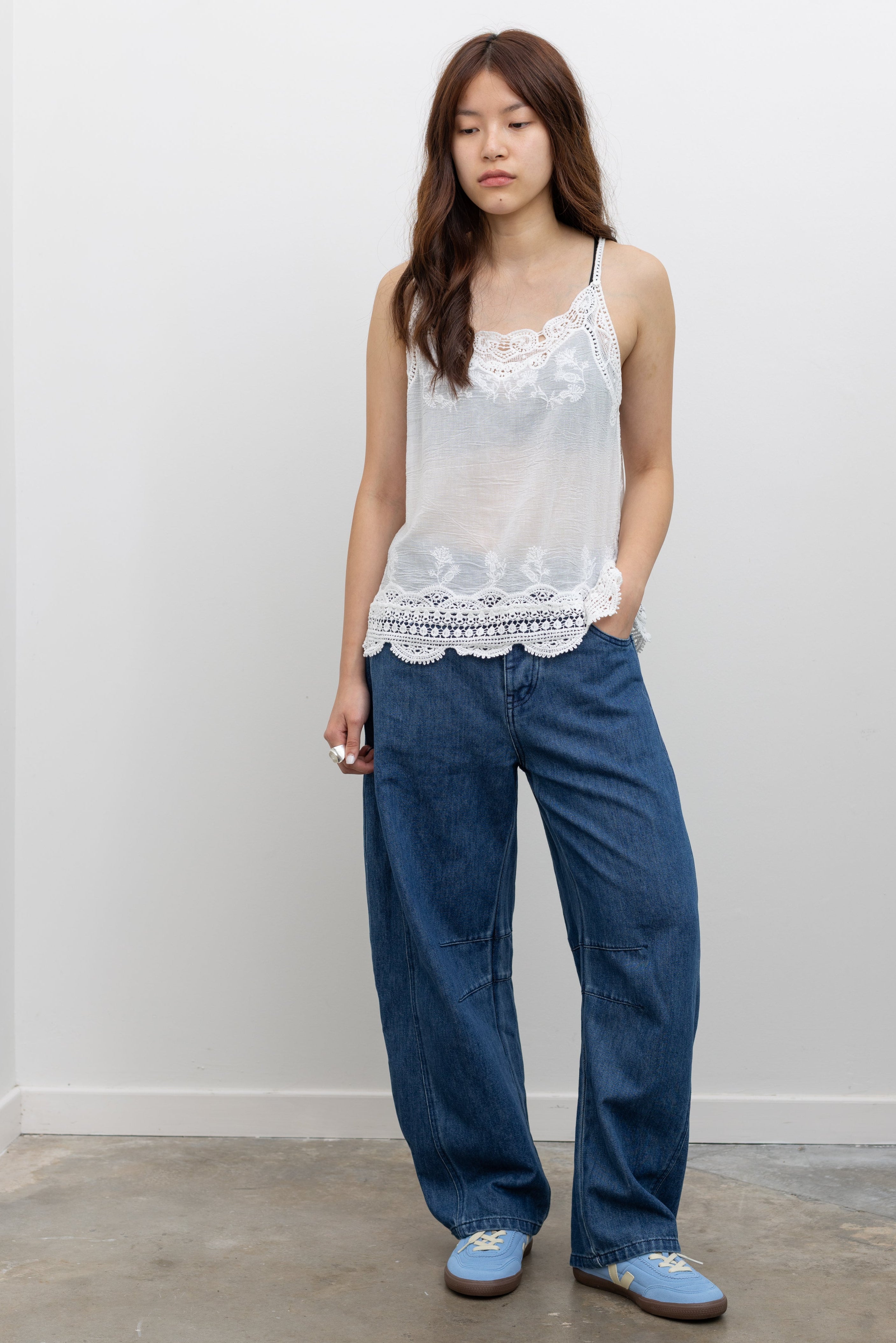 Model wearing Collective blue denim balloon leg pants with a relaxed curved silhouette and full-length hem at Alas Eius.