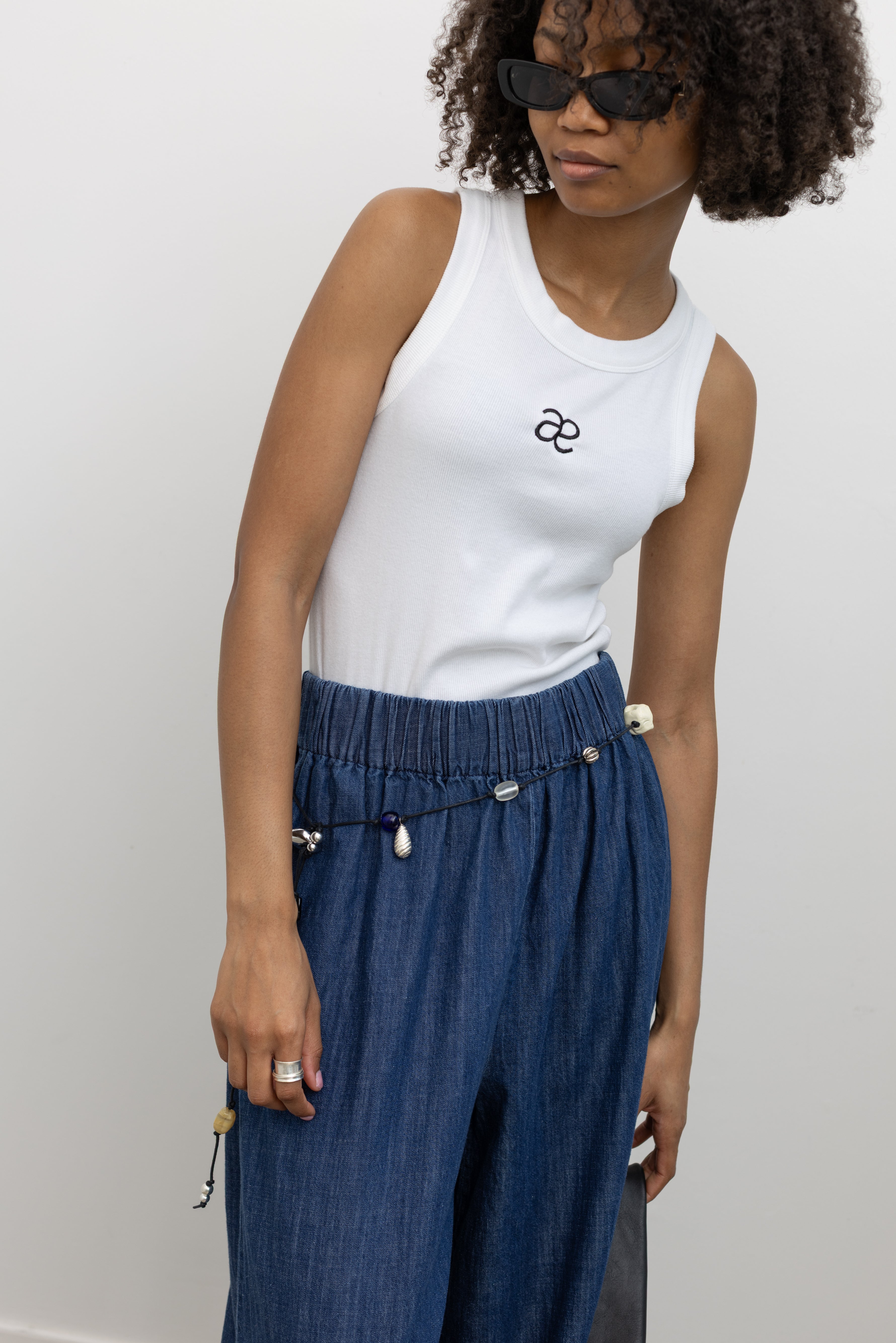 Collective Blue Denim High Waisted  Wide Leg Pull On Pant paired with Alas Eius Exclusive Logo Tank and a vintage bead belt at Alas Eius.