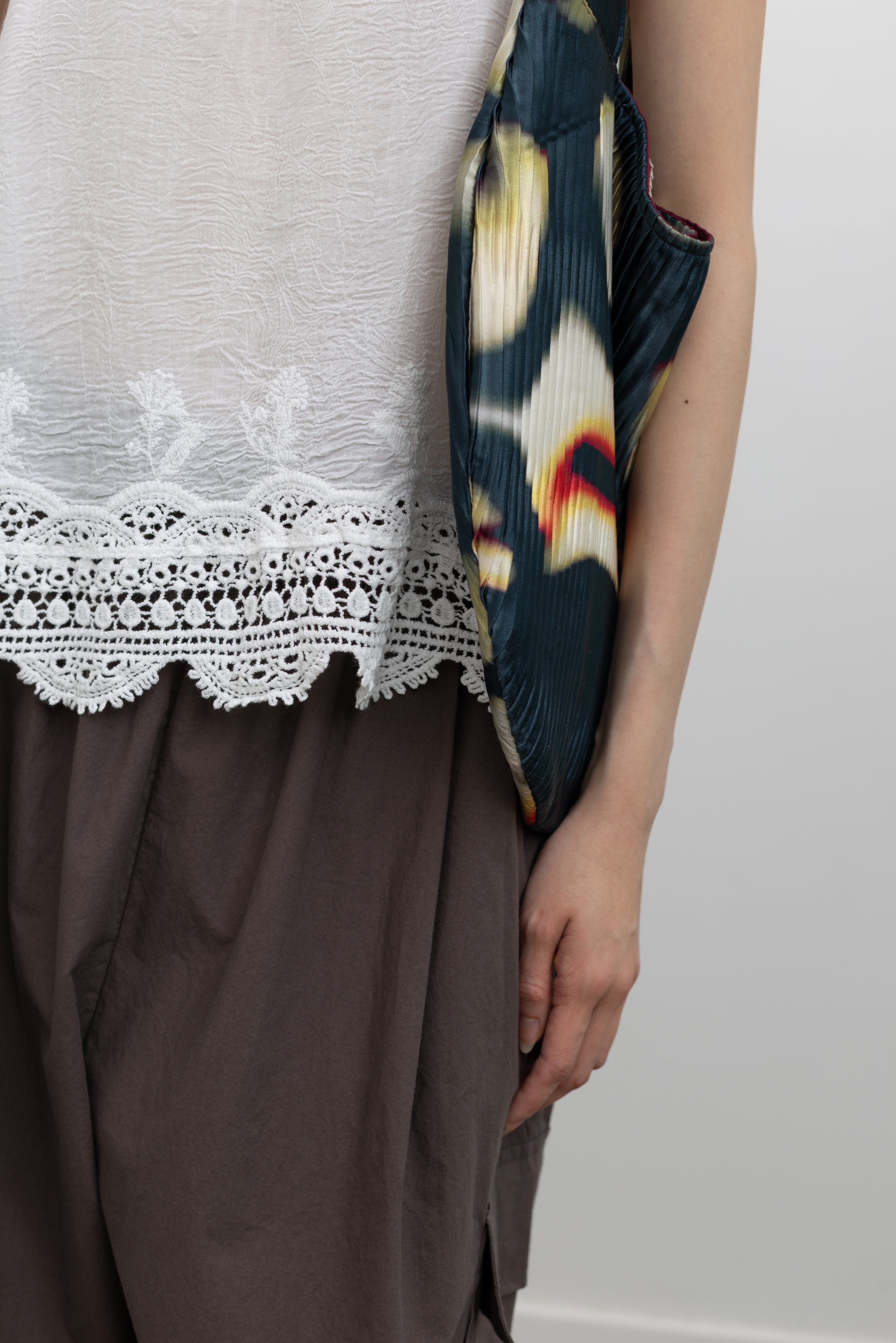 Collective boho-inspired white cotton camisole tank with delicate lace trim accents and soft draped silhouette, styled as a summer festival top and relaxed vacation wardrobe piece at Alas Eius