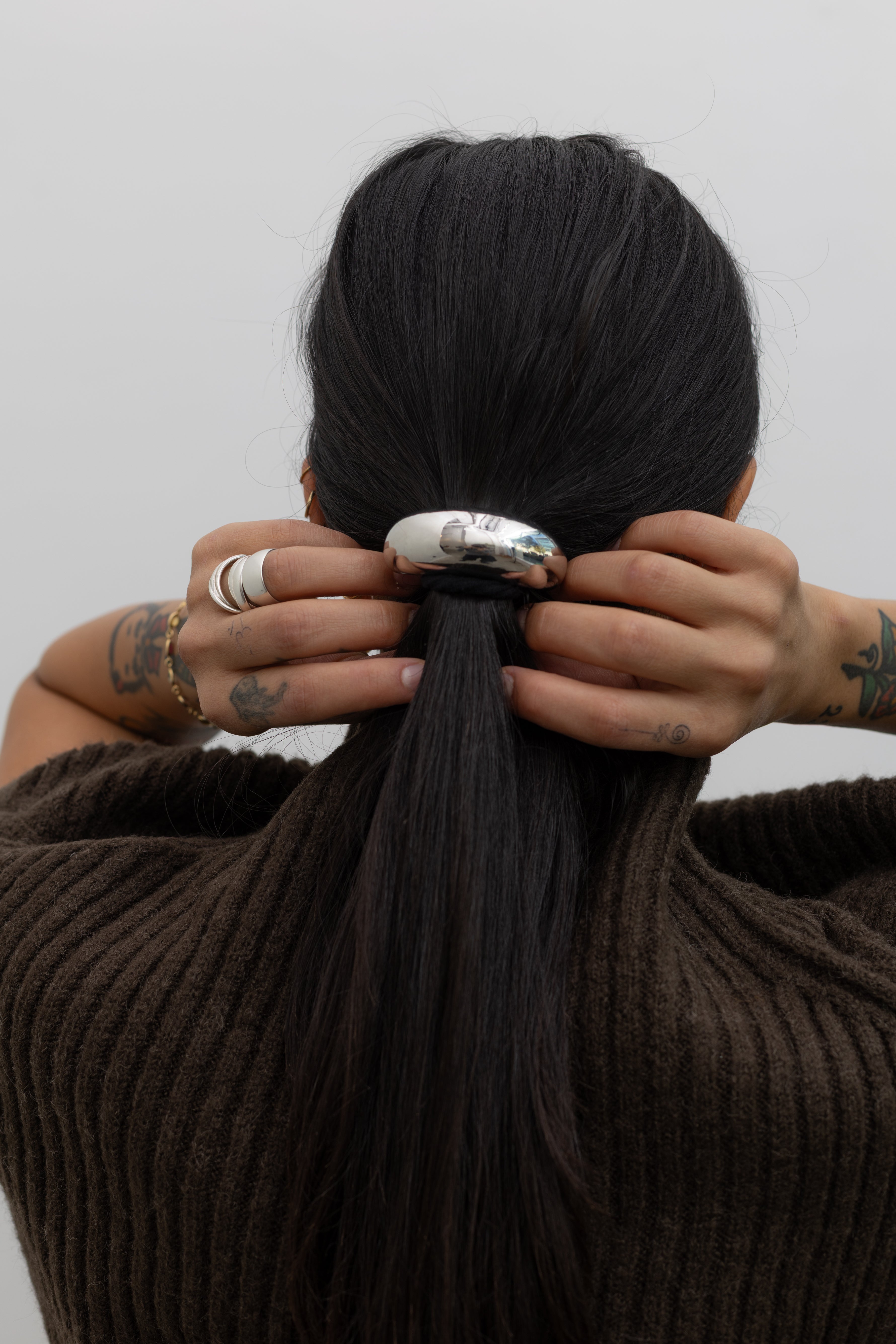 Woman wearing a contemporary Collective Silver Crescent Metal Cuff Hair Tie Accessory at Alas Eius