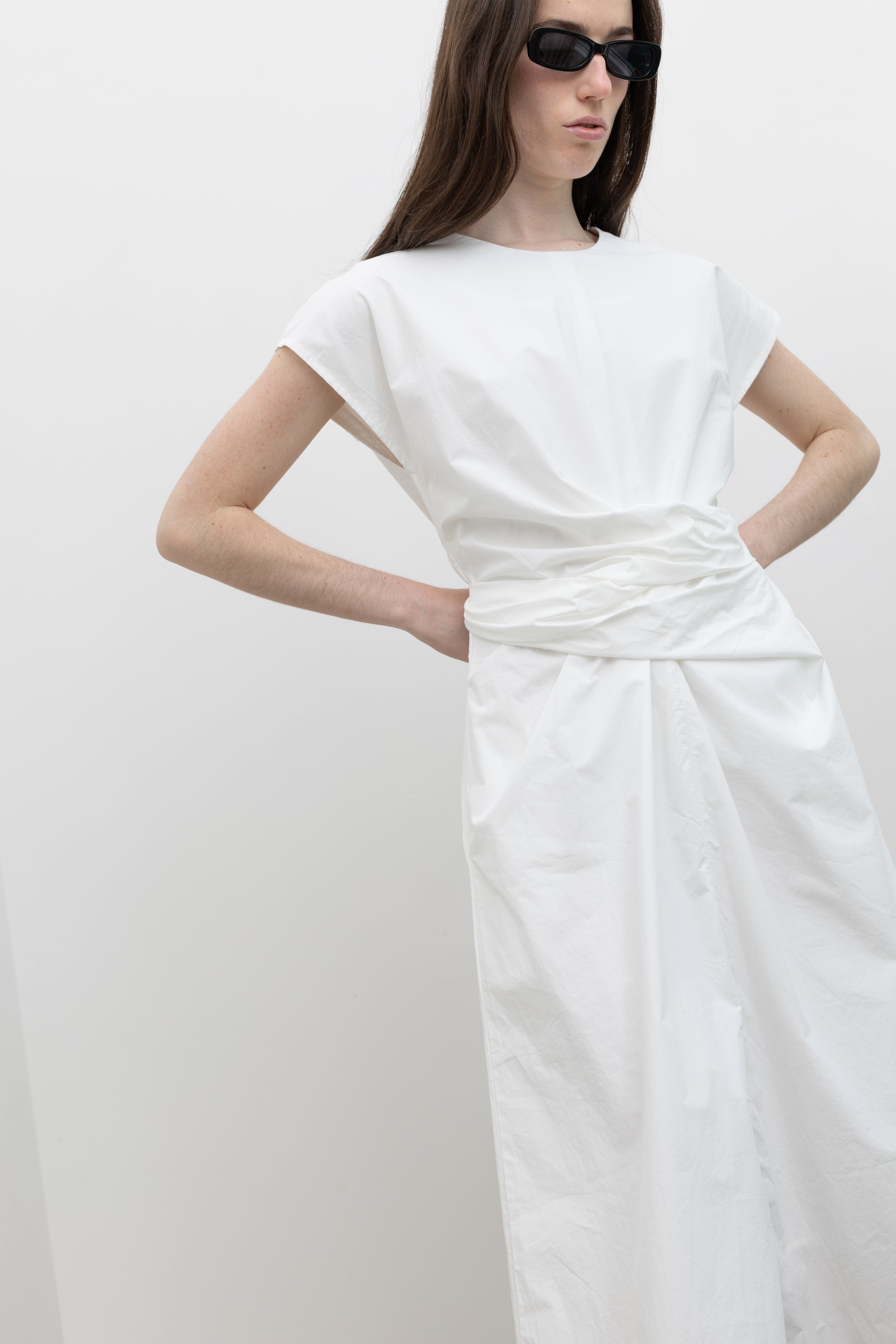 Crisp cotton midi dress by Collective featuring refined cap sleeves, discreet side pockets, a button closure at the back neck, and a self-fabric tie waist for adjustable shaping, worn cinched or relaxed at Alas Eius.