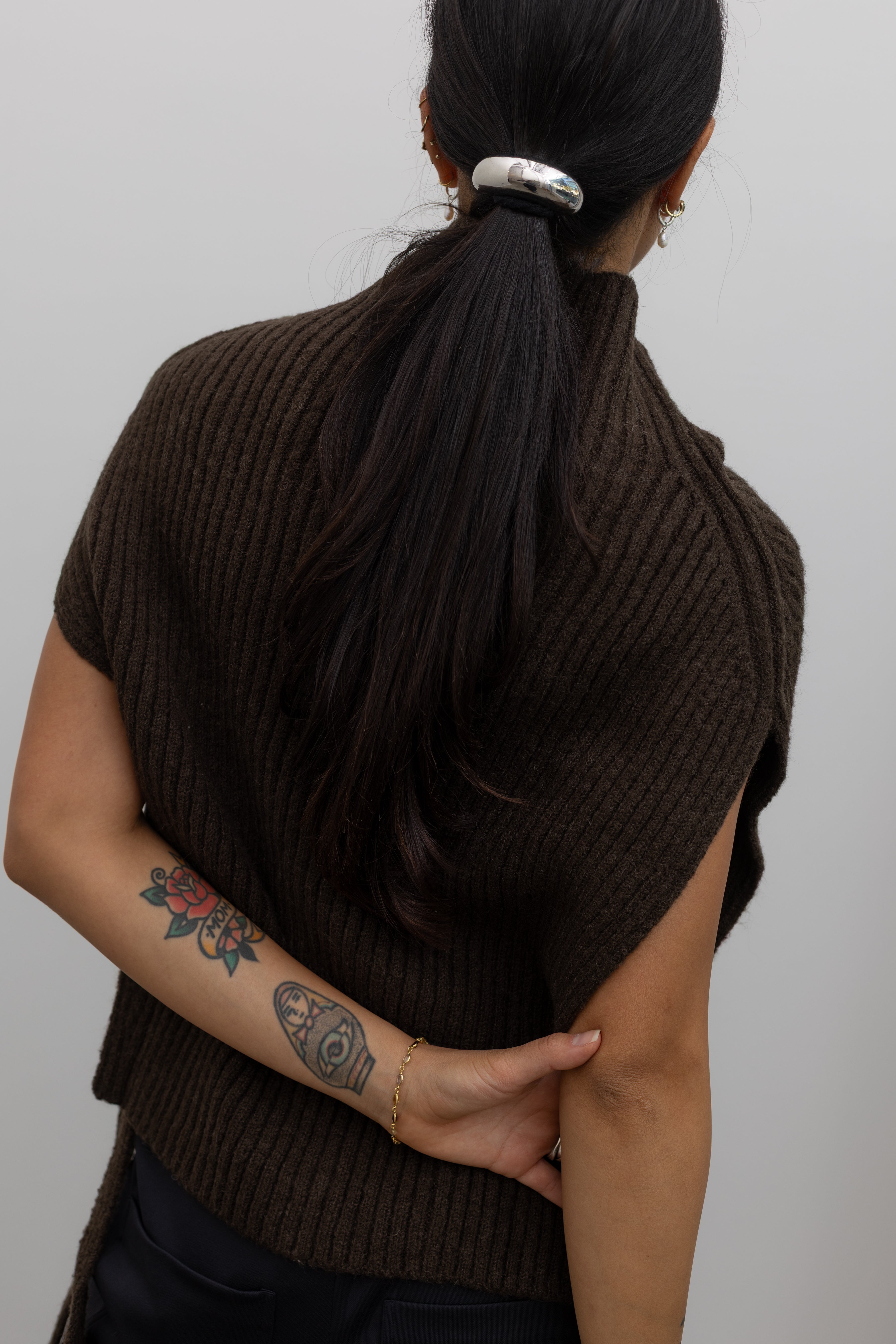 Back view of a woman wearing elevated hair accessory in a contemporary Collective Silver Crescent Metal Cuff Hair Tie Accessory at Alas Eius