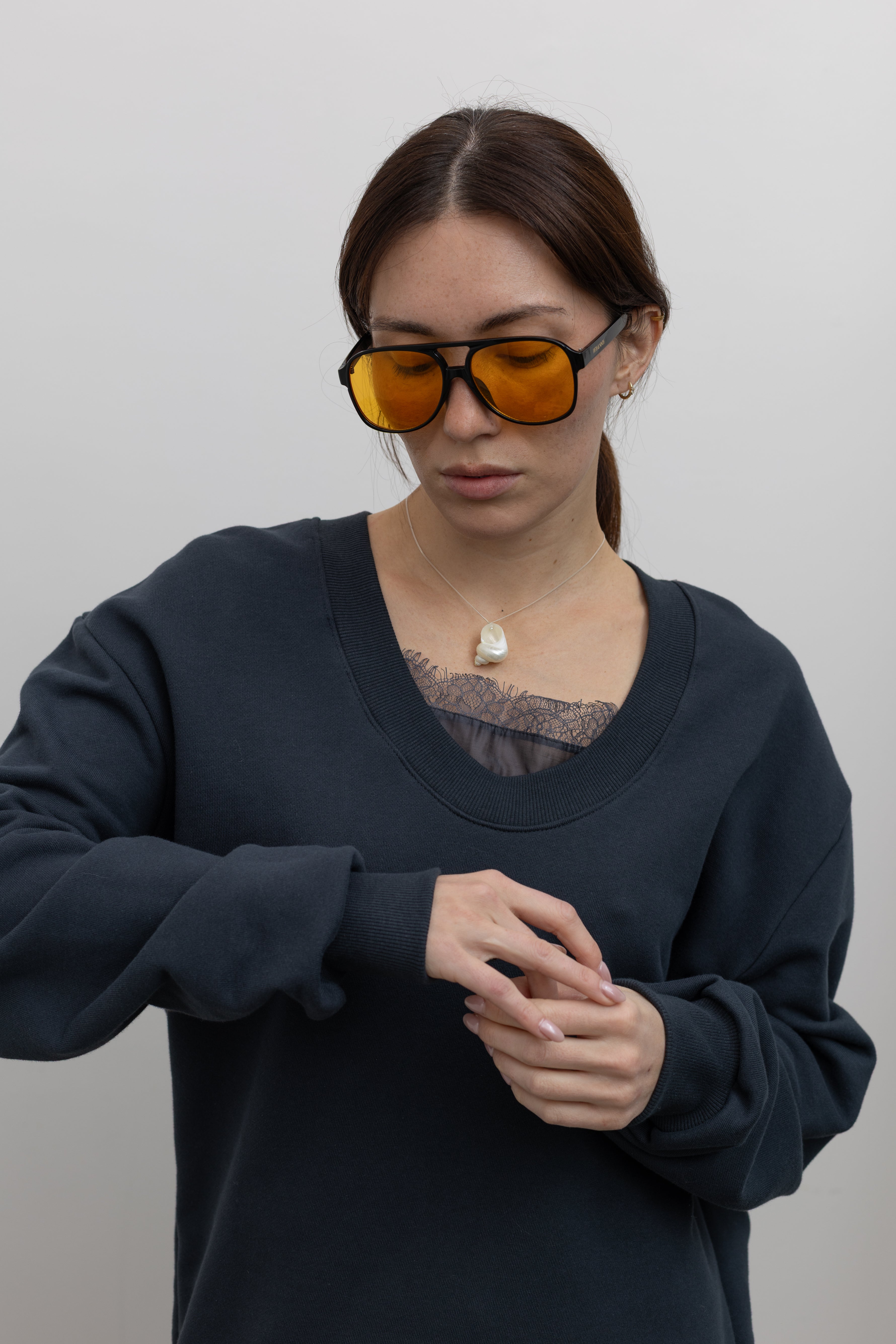 Detailed product view of Woman standing wearing Spring fashion in a Collective Navy Lace Trim Cotton Oversized Jumper with sunglasses at Alas Eius 