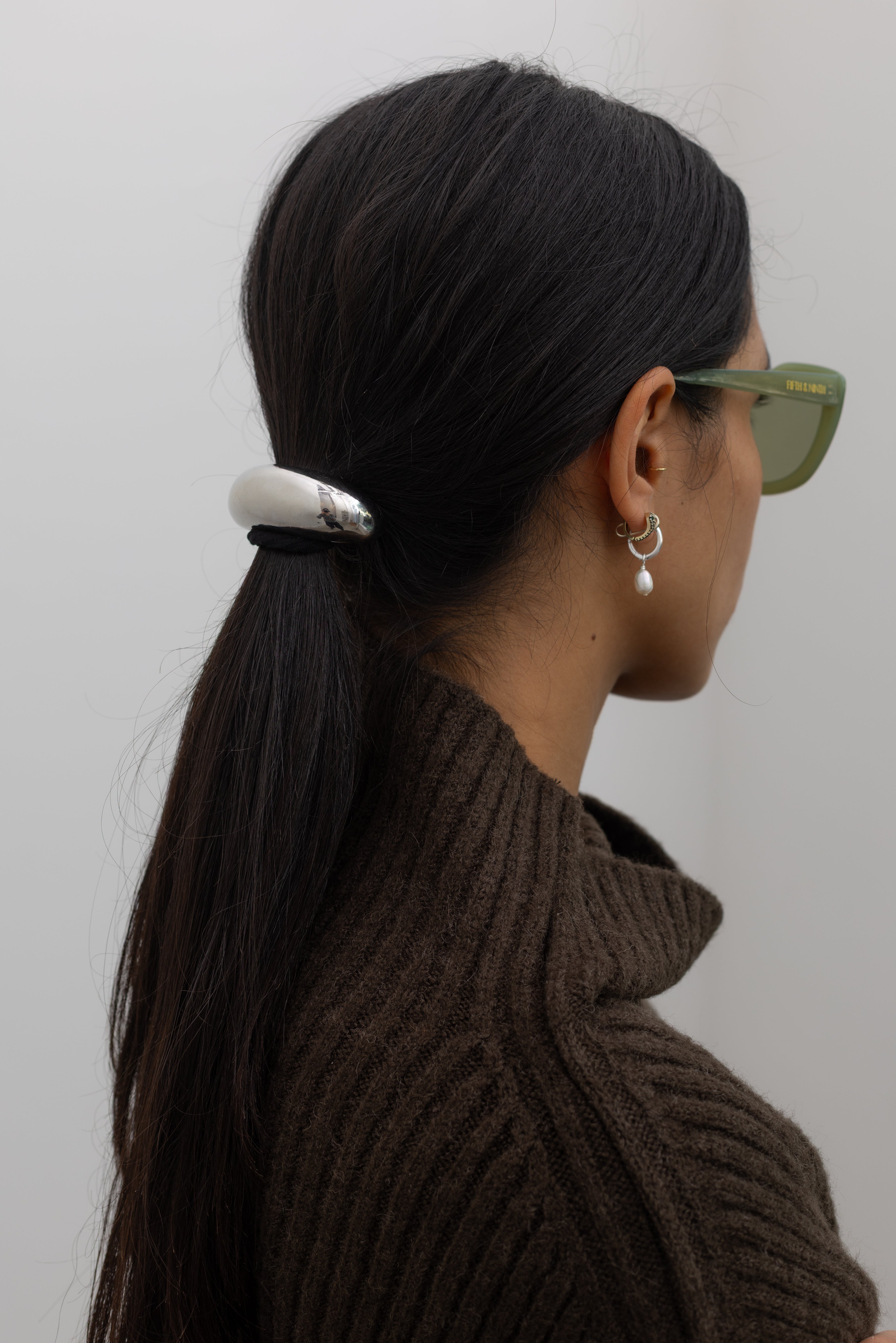 Woman wearing a contemporary Collective Silver Crescent Metal Cuff Hair Tie Accessory at Alas Eius