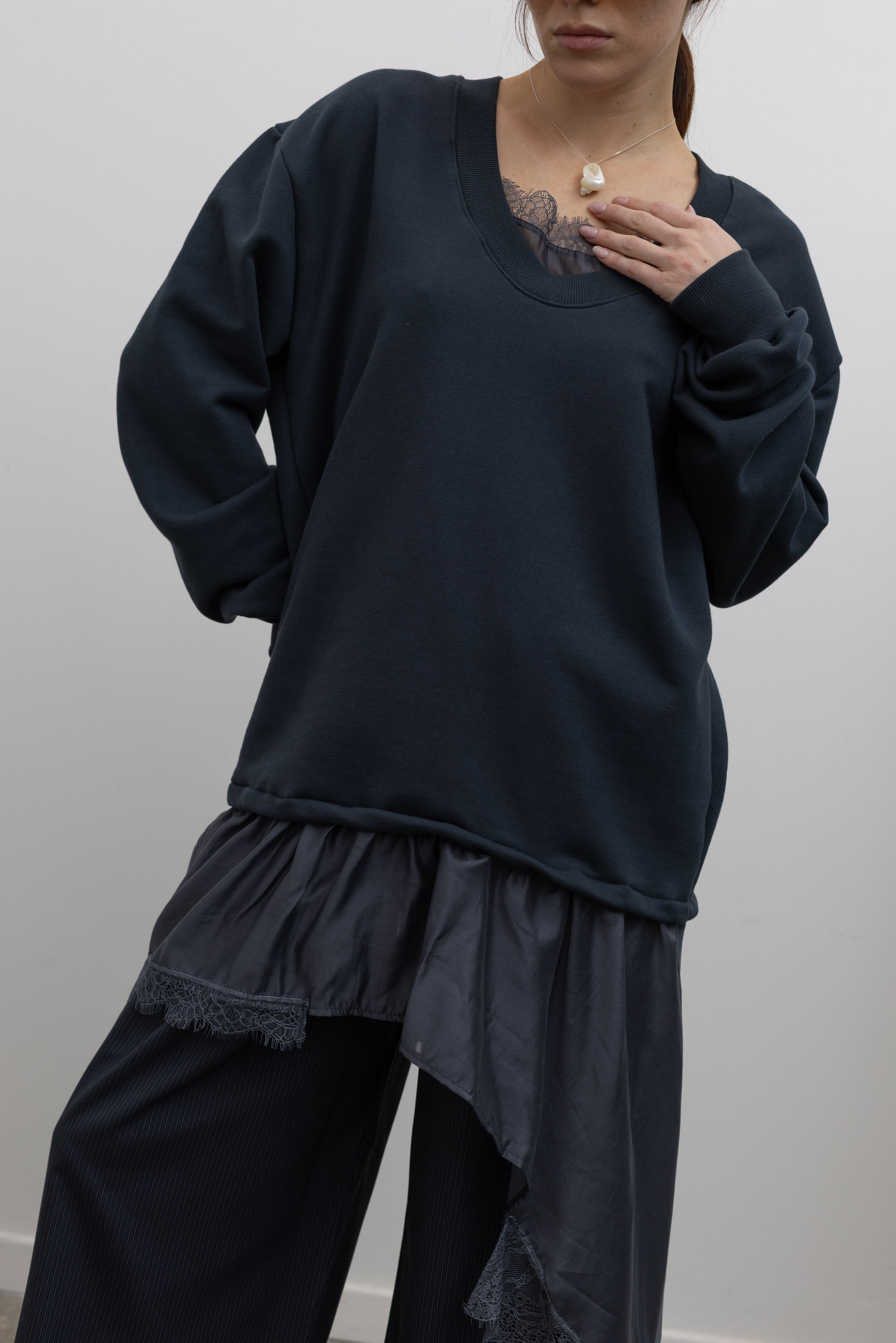 Product view of Woman standing wearing Spring fashion in a Collective Navy Lace Trim Cotton Oversized Jumper and navy blue pinstripe trousers at Alas Eius 