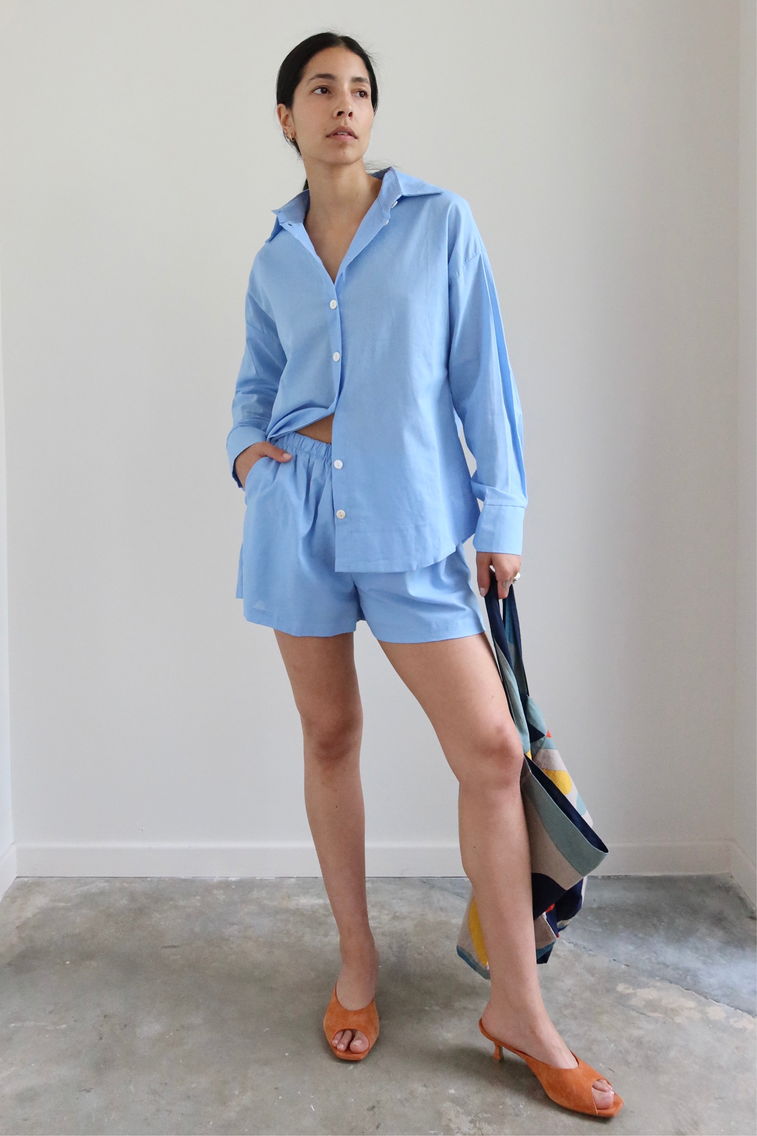 Woman wearing Spring / Summer fashion in a pair of Collective Light Blue Cotton Pull On Shorts at Alas Eius. 