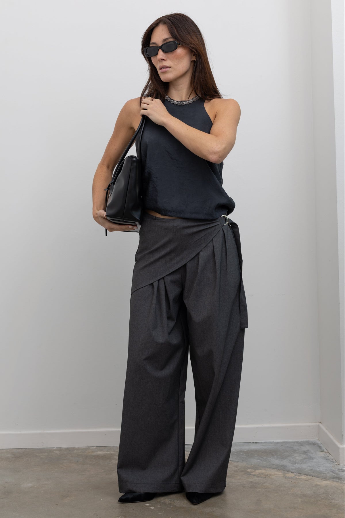 Collective tailored trousers with wrap-inspired silhouette and buckle details at Alas Eius