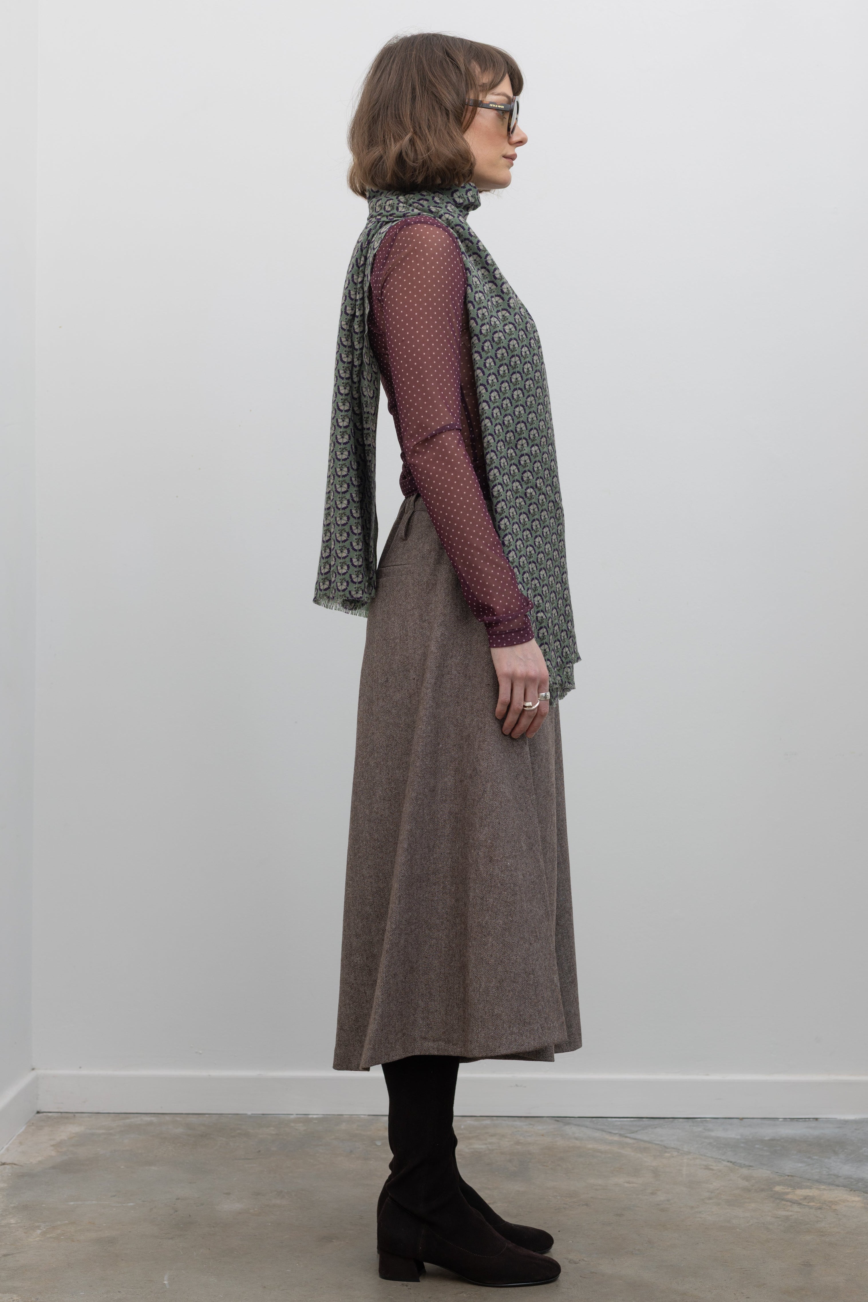 Side view of a Woman wearing Collective Brown wool Herringbone Wide Leg Culotte Pants at Alas Eius
