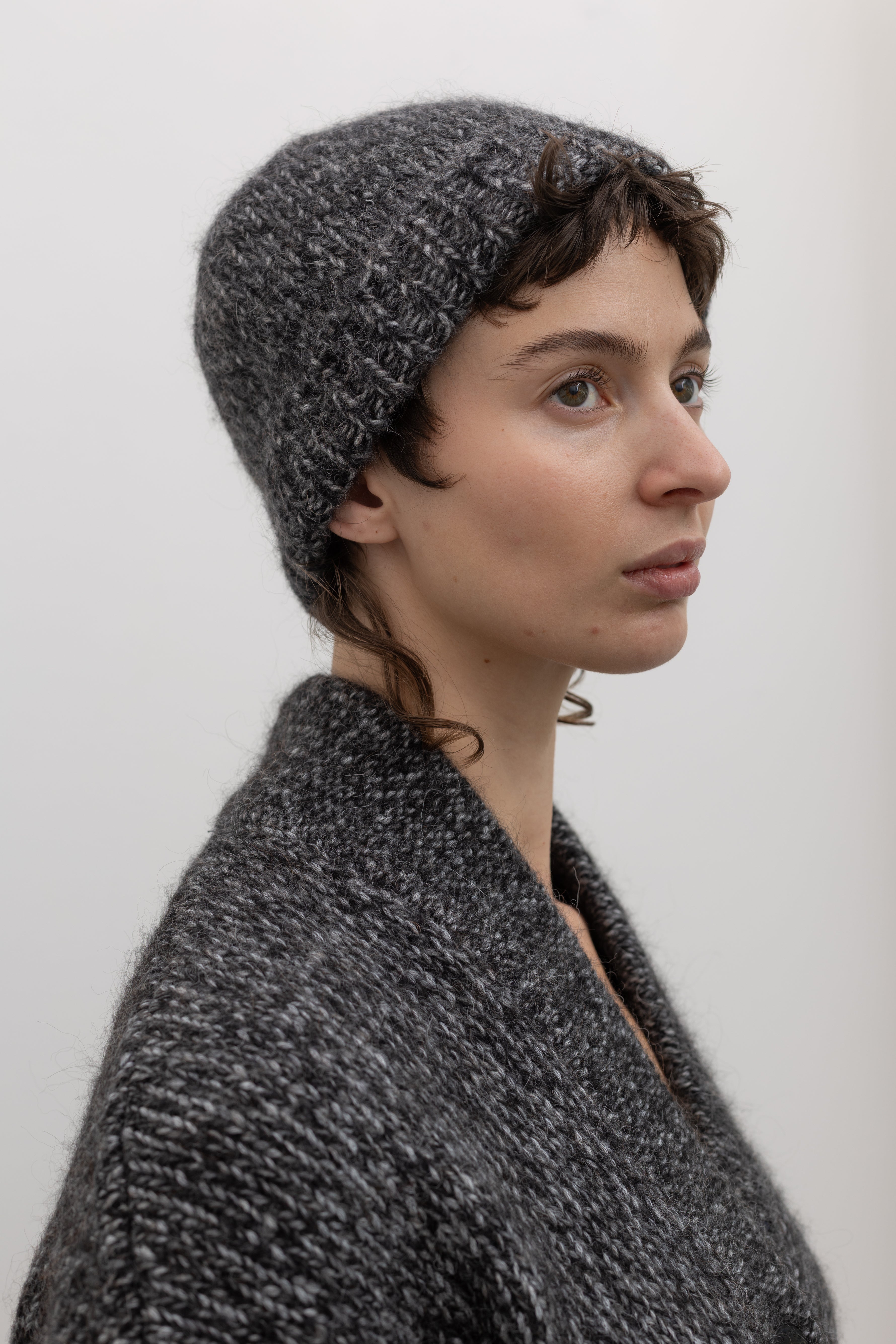 Woman wearing winter fashion accessory in a Cordera Black Alpaca Blend Melange Beanie at Alas Eius