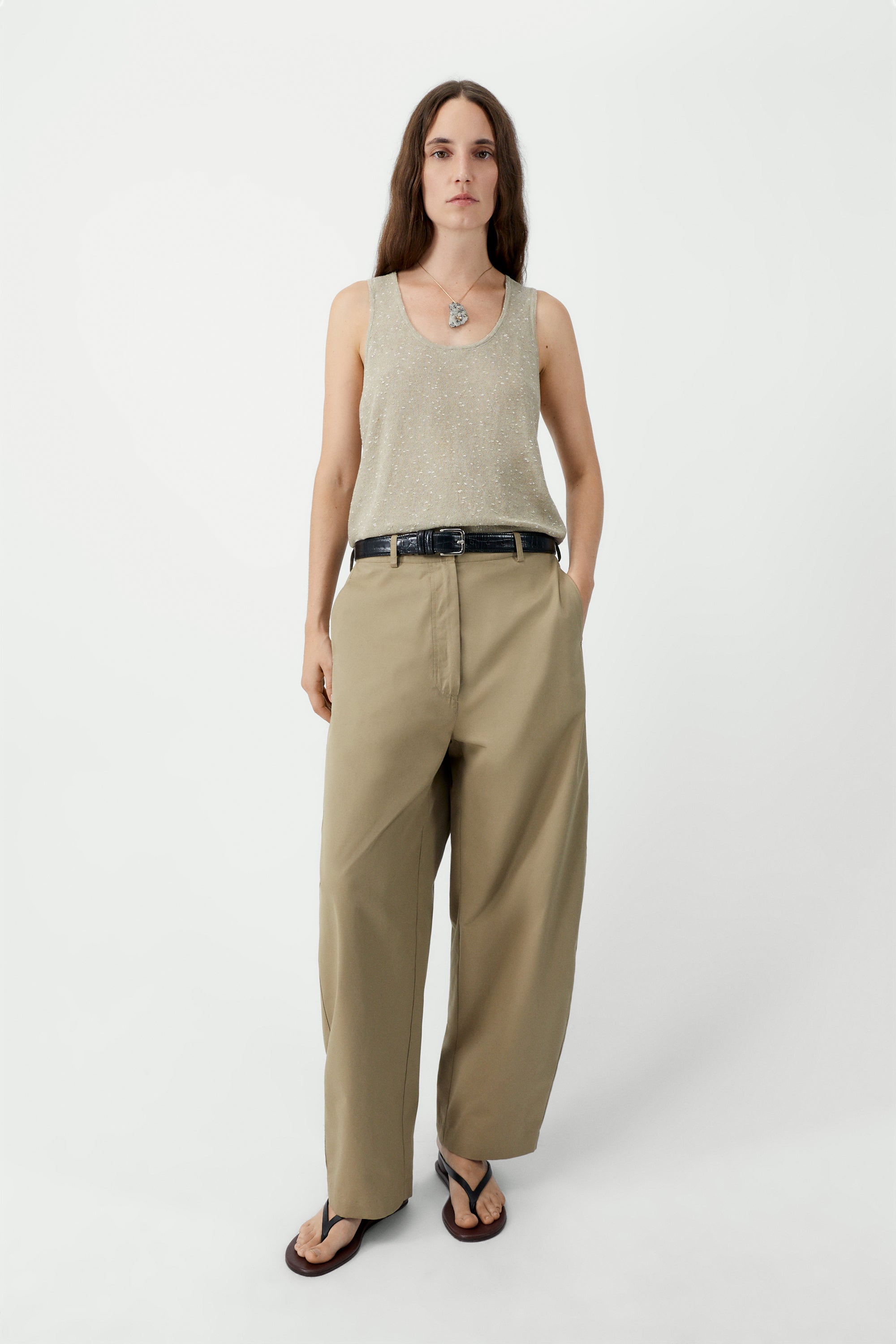 Full length front view of a woman standing wearing a versatile spring layering essential in the Cordera beige linen and cotton blend flecked tank top at Alas Eius.

This cardigan is ethically and carefully manufactured in La Coruña, with Japanese knitting machines and finished by hand. Made in Spain.