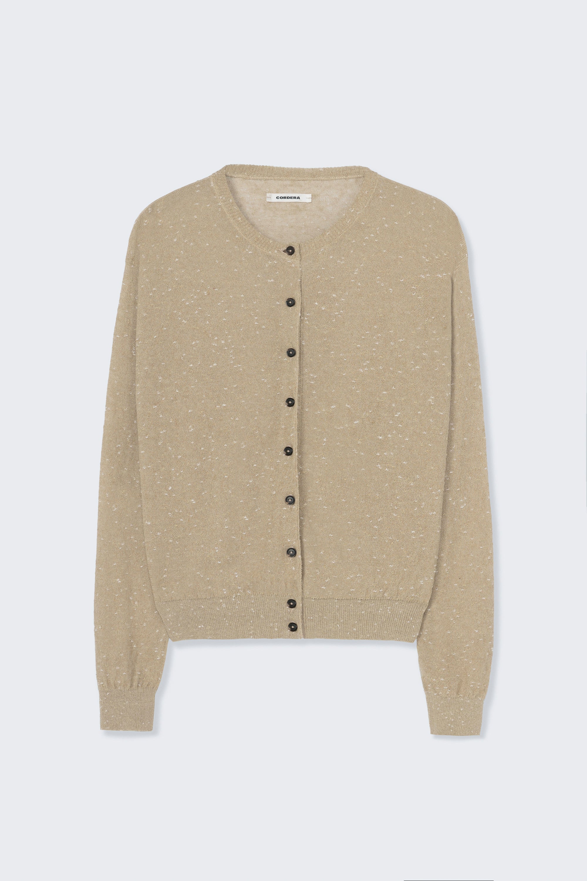 Front product view of the Cordera cream linen and cotton blend flecked oversized cardigan featuring a crew neck and finished with ribbed trims at the collar, hem, and cuffs, it fastens with small front buttons at Alas Eius.  

This cardigan is ethically and carefully manufactured in La Coruña, with Japanese knitting machines and finished by hand.