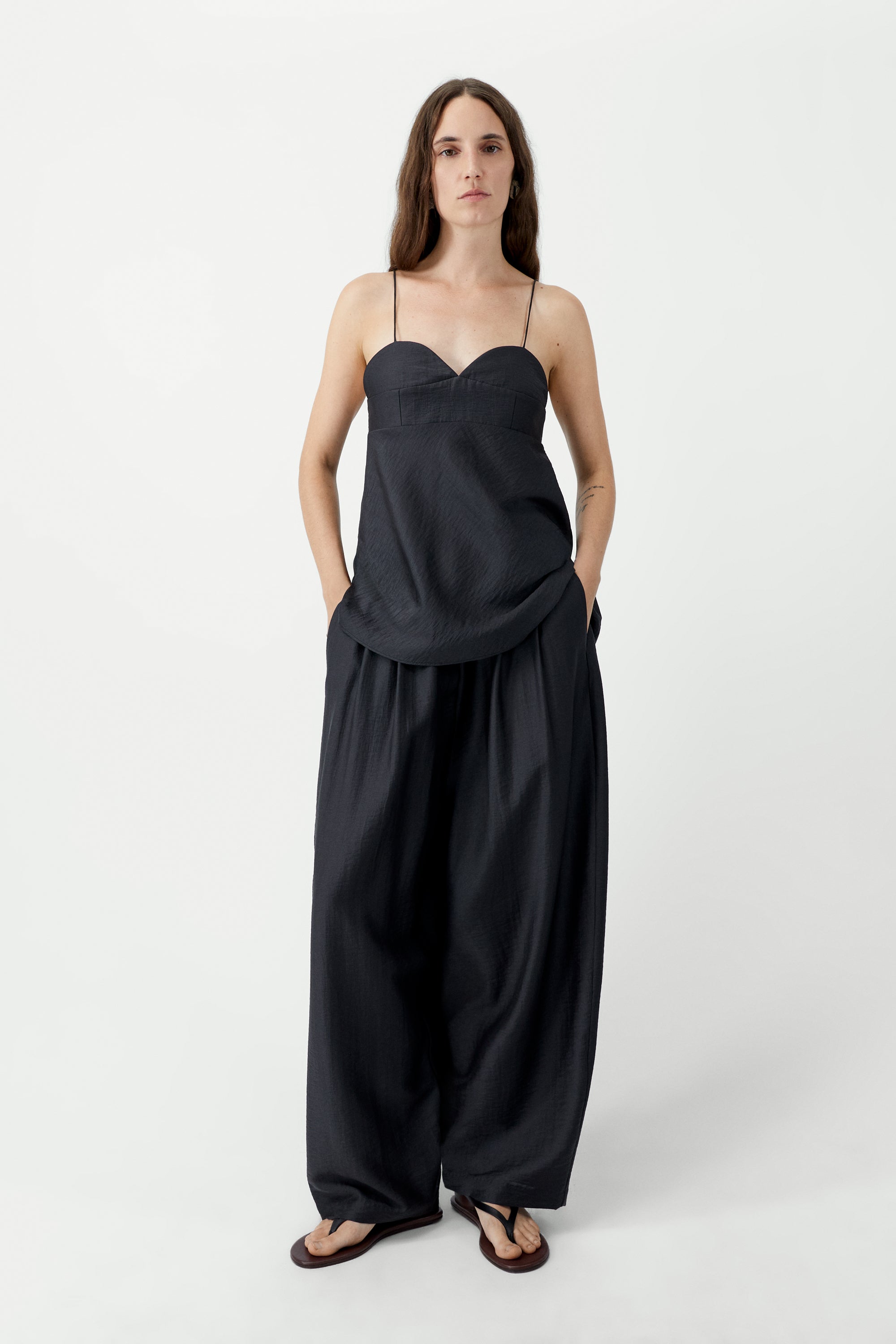 Front view of elevated spring fashion in Cordera espresso brown maxi pants featuring a baggy fit, drawstring elastic waistband, and side pockets at Alas Eius. 