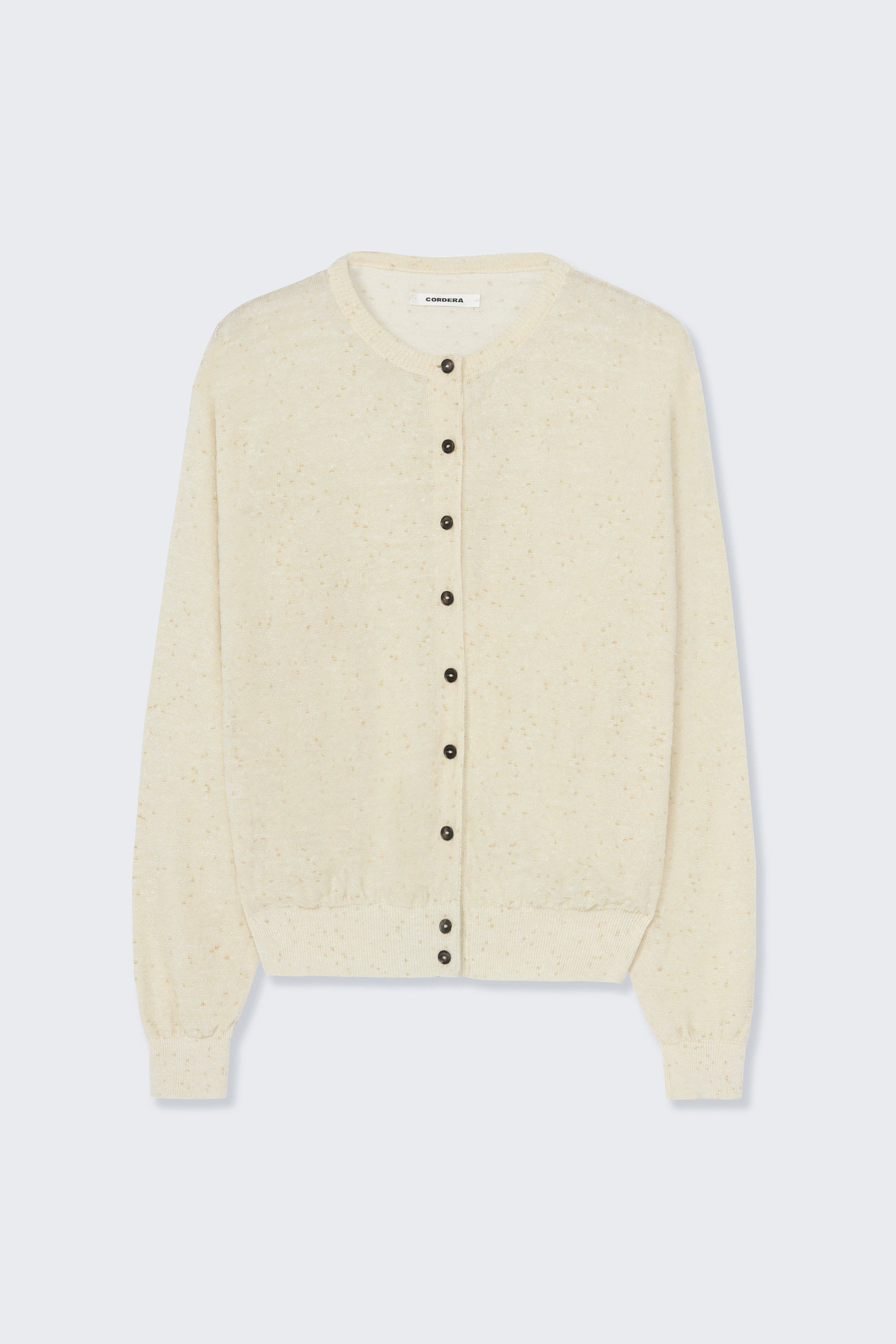 Front product view of the Cordera cream linen and cotton blend flecked oversized cardigan featuring a crew neck and finished with ribbed trims at the collar, hem, and cuffs, it fastens with small front buttons at Alas Eius.  

This cardigan is ethically and carefully manufactured in La Coruña, with Japanese knitting machines and finished by hand.