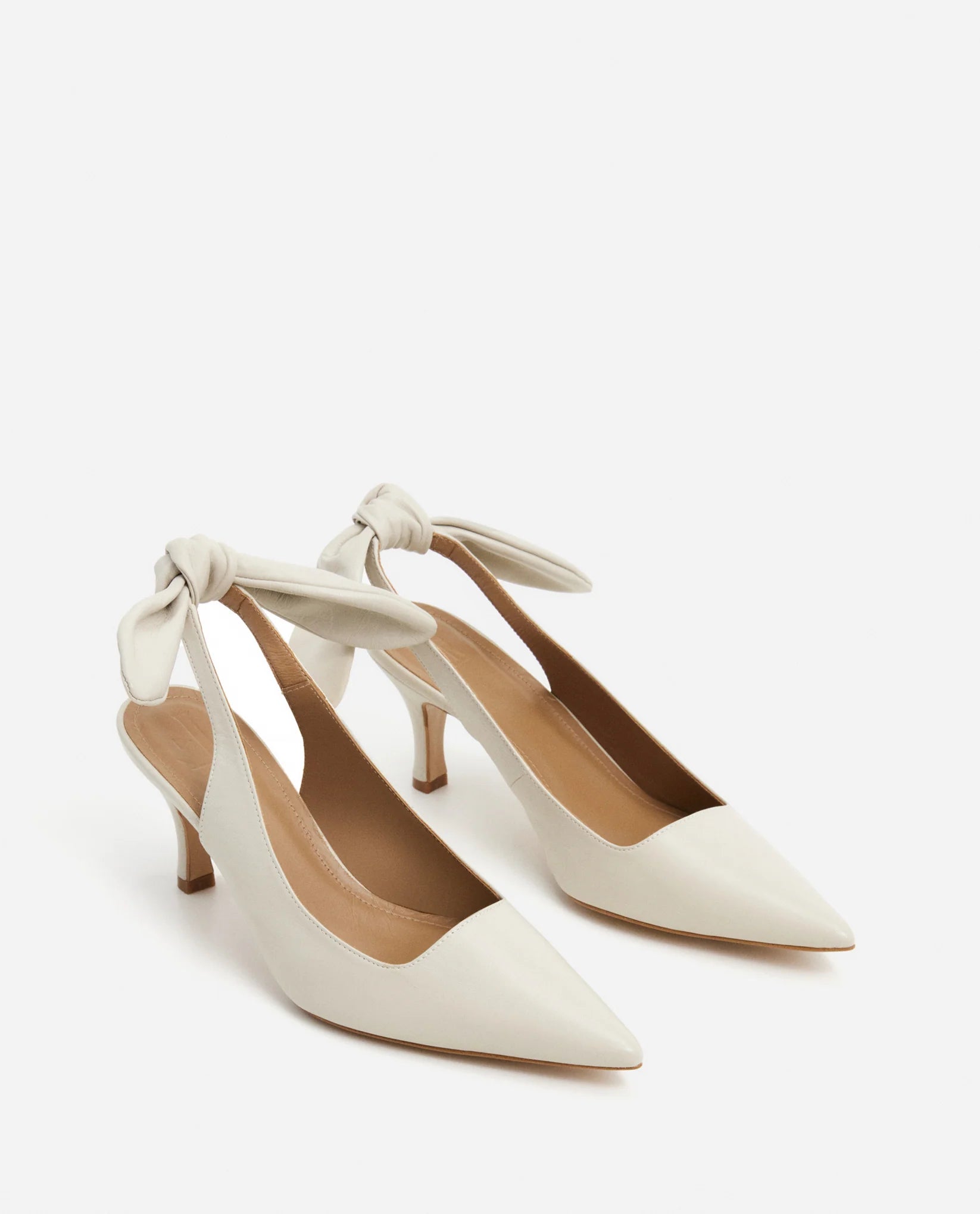 3/4 view of the Flattered Goat Leather Franchesca Removable Bow sling back Heels with pointed toe in Creme at Alas Eius