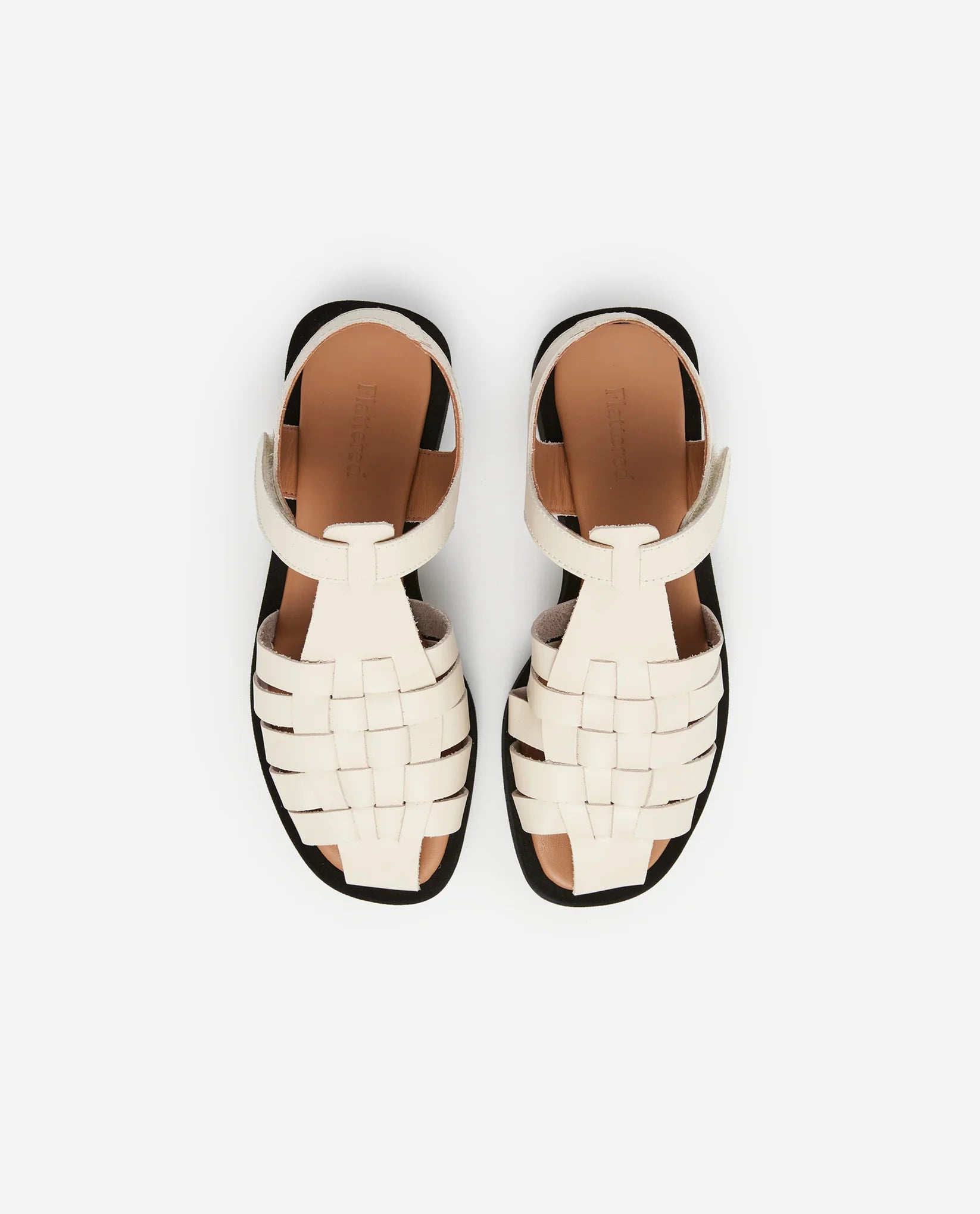 Aerial view of a pair of Flattered brand Vanilla White Gigi Leather Fisherman Platform Sandals at Alas Eius