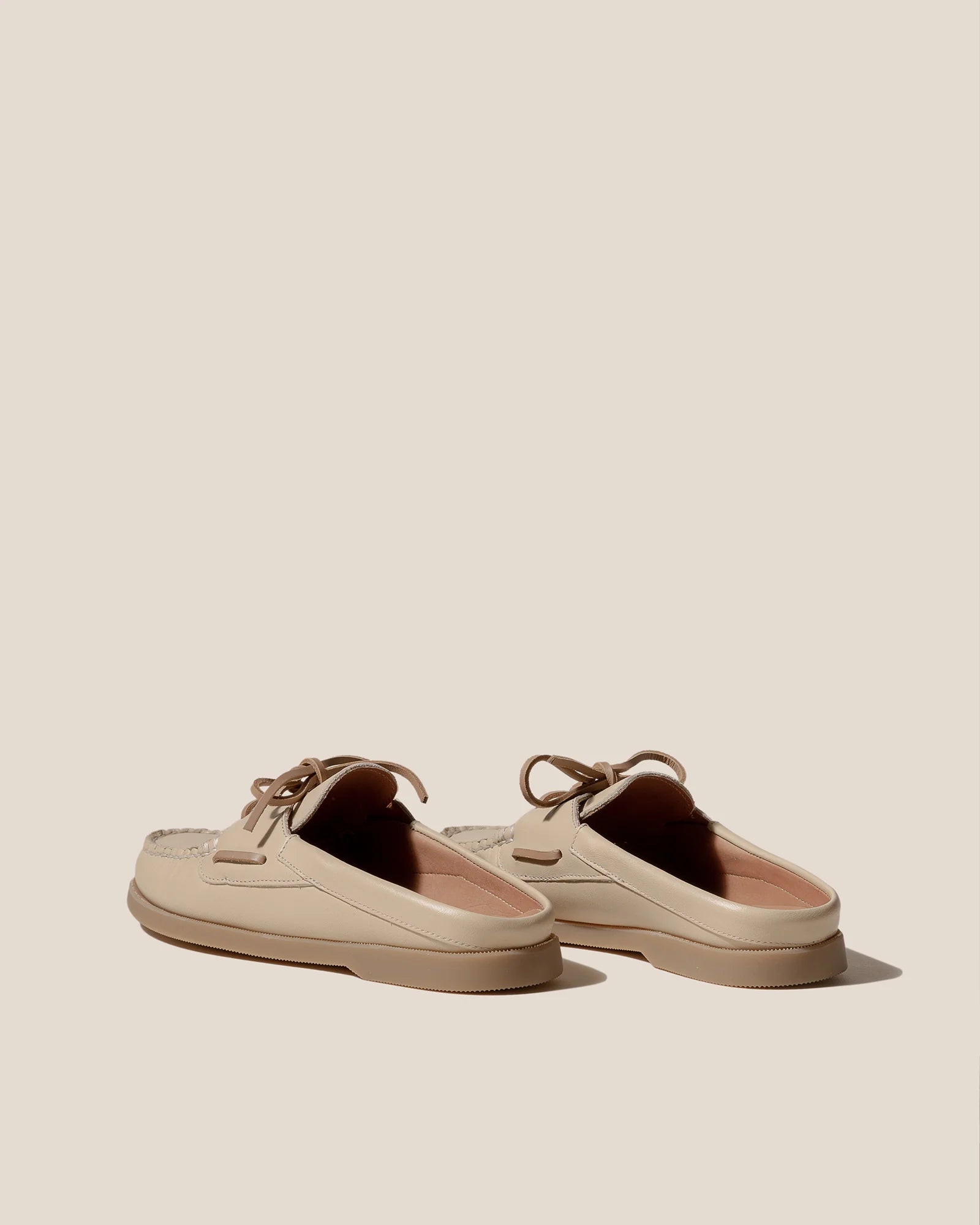 Side view of elevated spring footwear in the Hereu Beige Saler Nautic Muled Loafers featuring a classic boat shoe shape with leather ties at Alas Eius.
