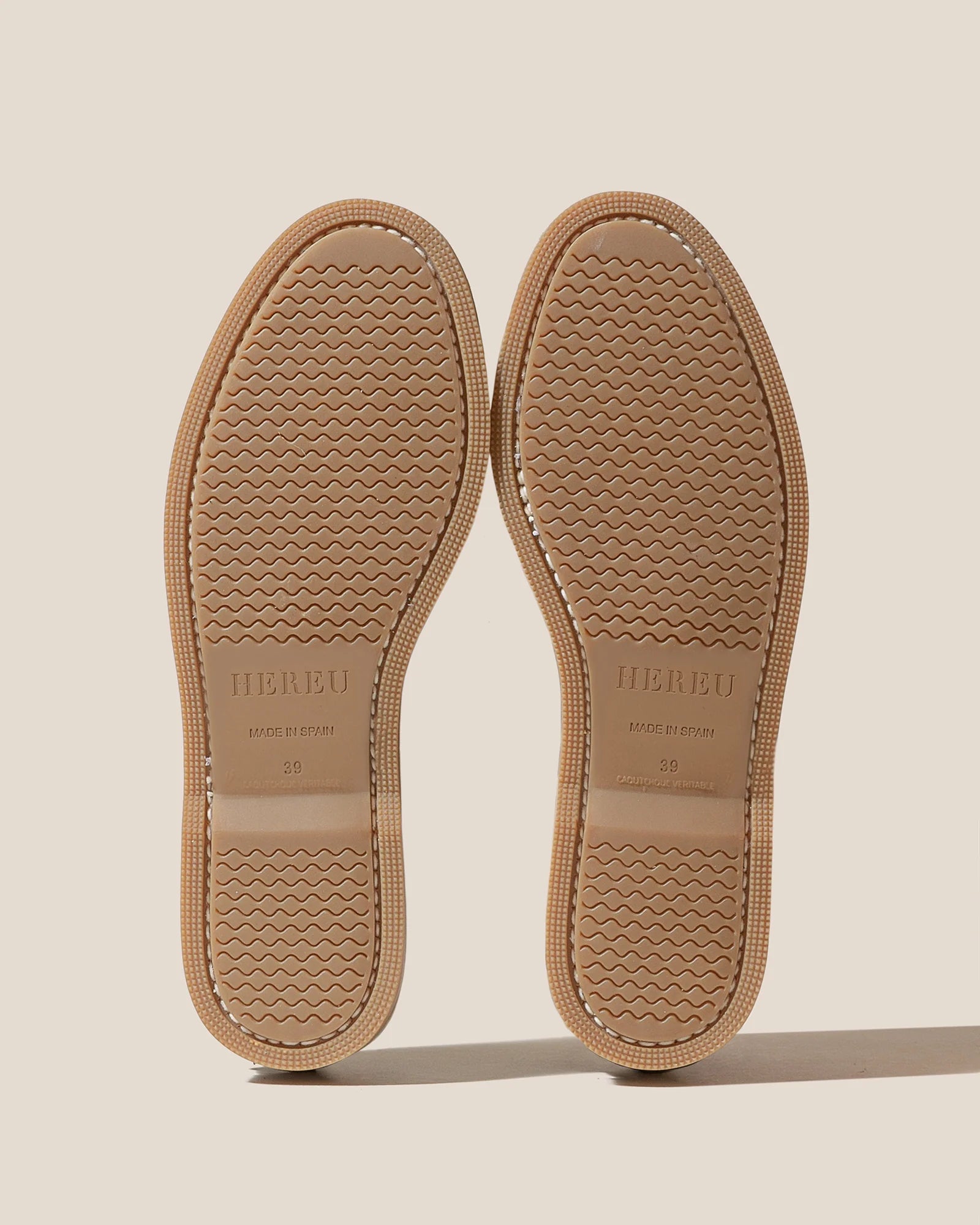 Bottom outsole view of elevated spring footwear in the Hereu Beige Saler Nautic Muled Loafers featuring a classic boat shoe shape with leather ties at Alas Eius.