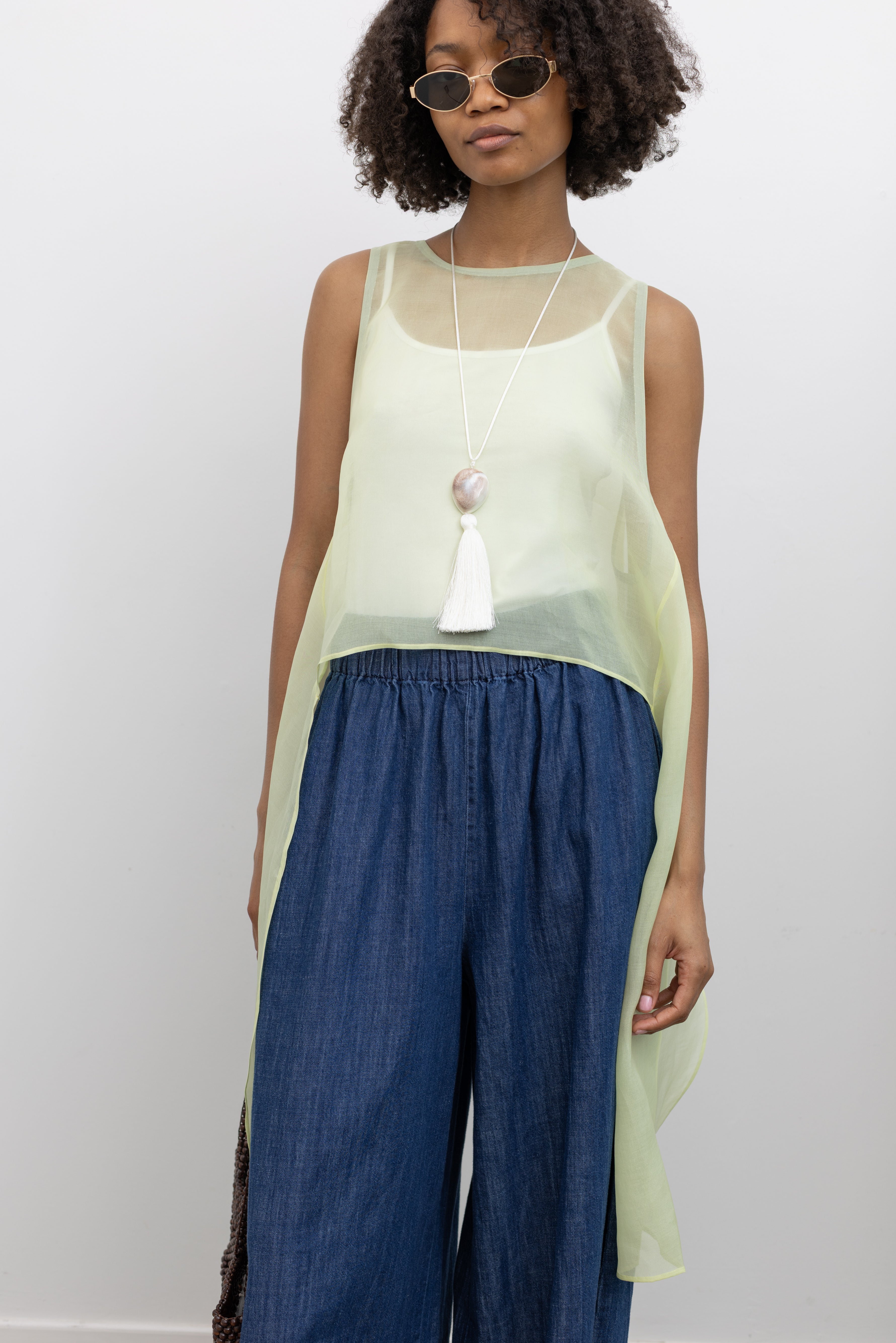 KAAREM sheer silk organza top with sculptural side panels and a wide neckline inspired by natural organic forms at Alas Eius. 