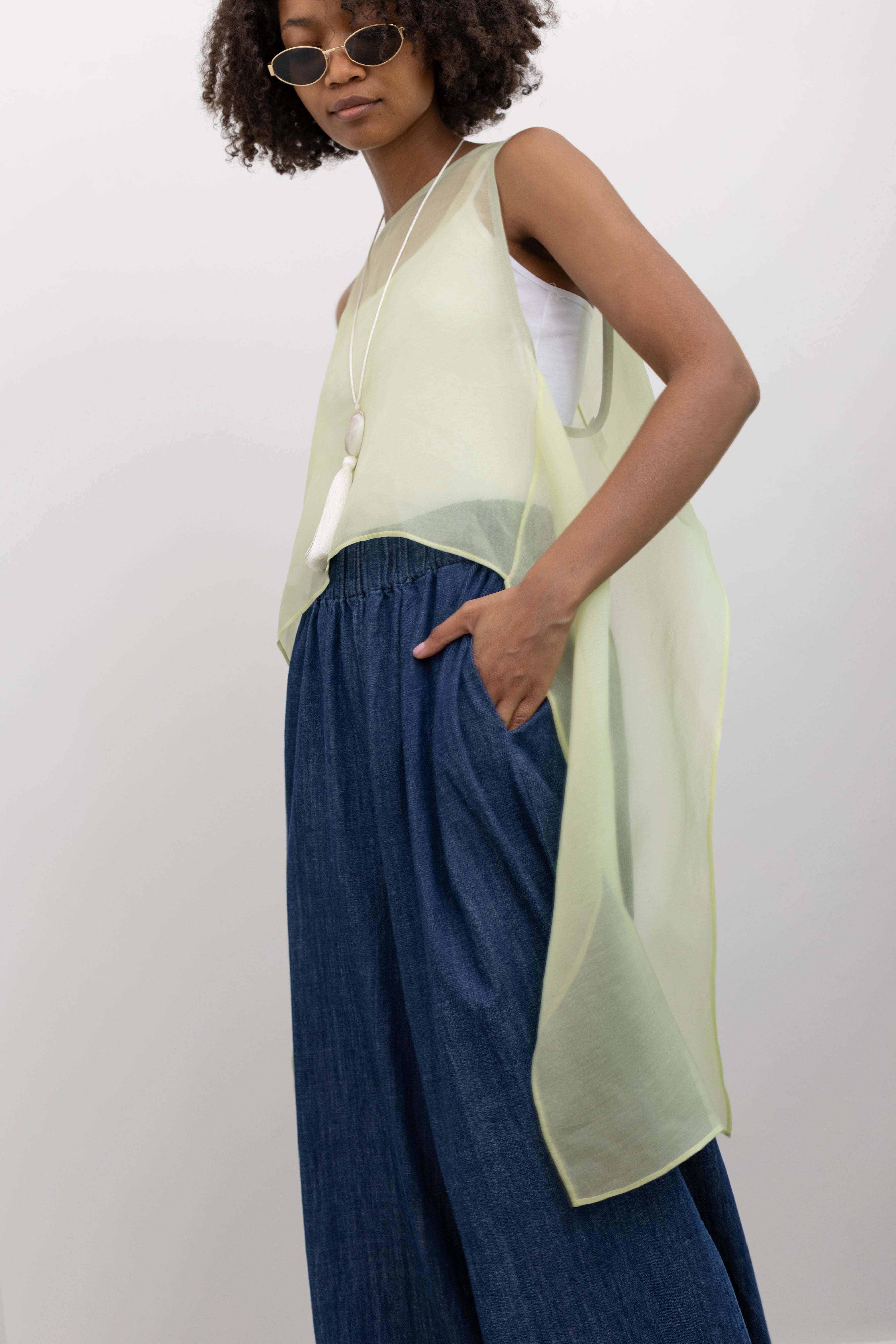 KAAREM airy silk organza top featuring organic shape-inspired side panels and a clean wide neckline finish at Alas Eius. 
