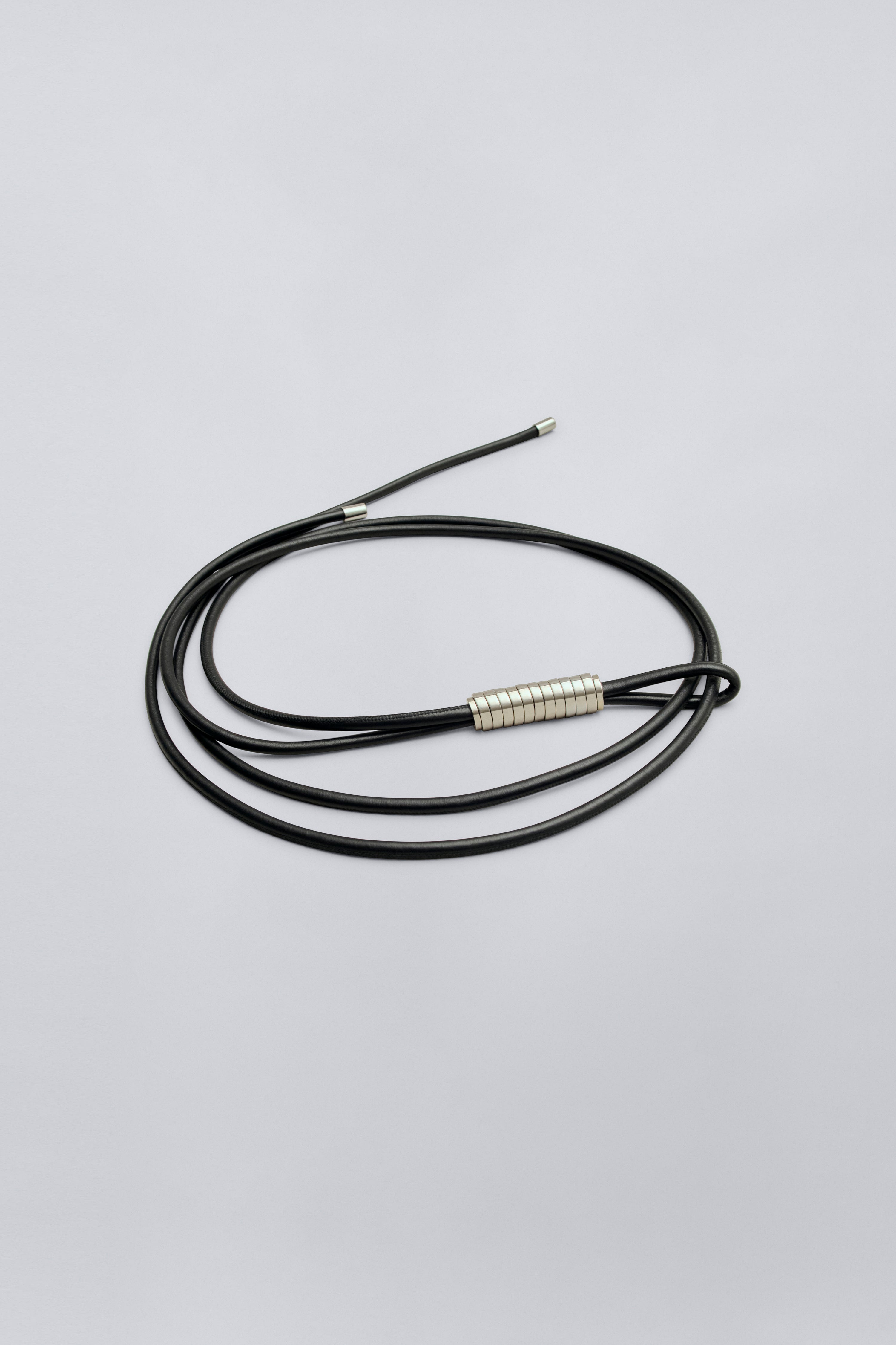 Product view of a contemporary womenswear Kallmeyer Lowell Black Leather Wrap cord belt with silver beaded detail at Alas Eius.