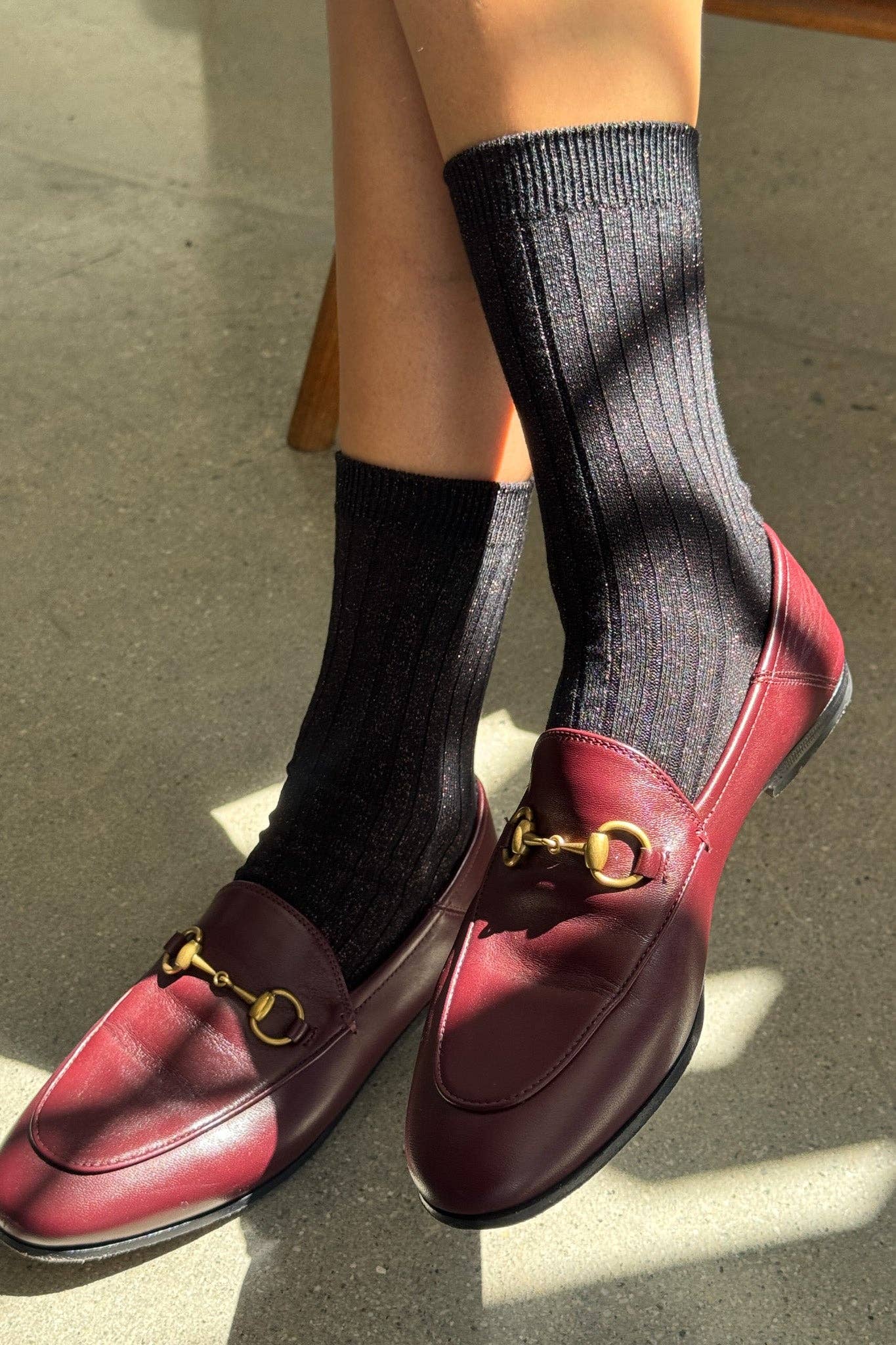 Woman wearing Copper Black Her Socks by Le Bon Shoppe with burgundy colored leather loafer flat shoe at Alas Eius