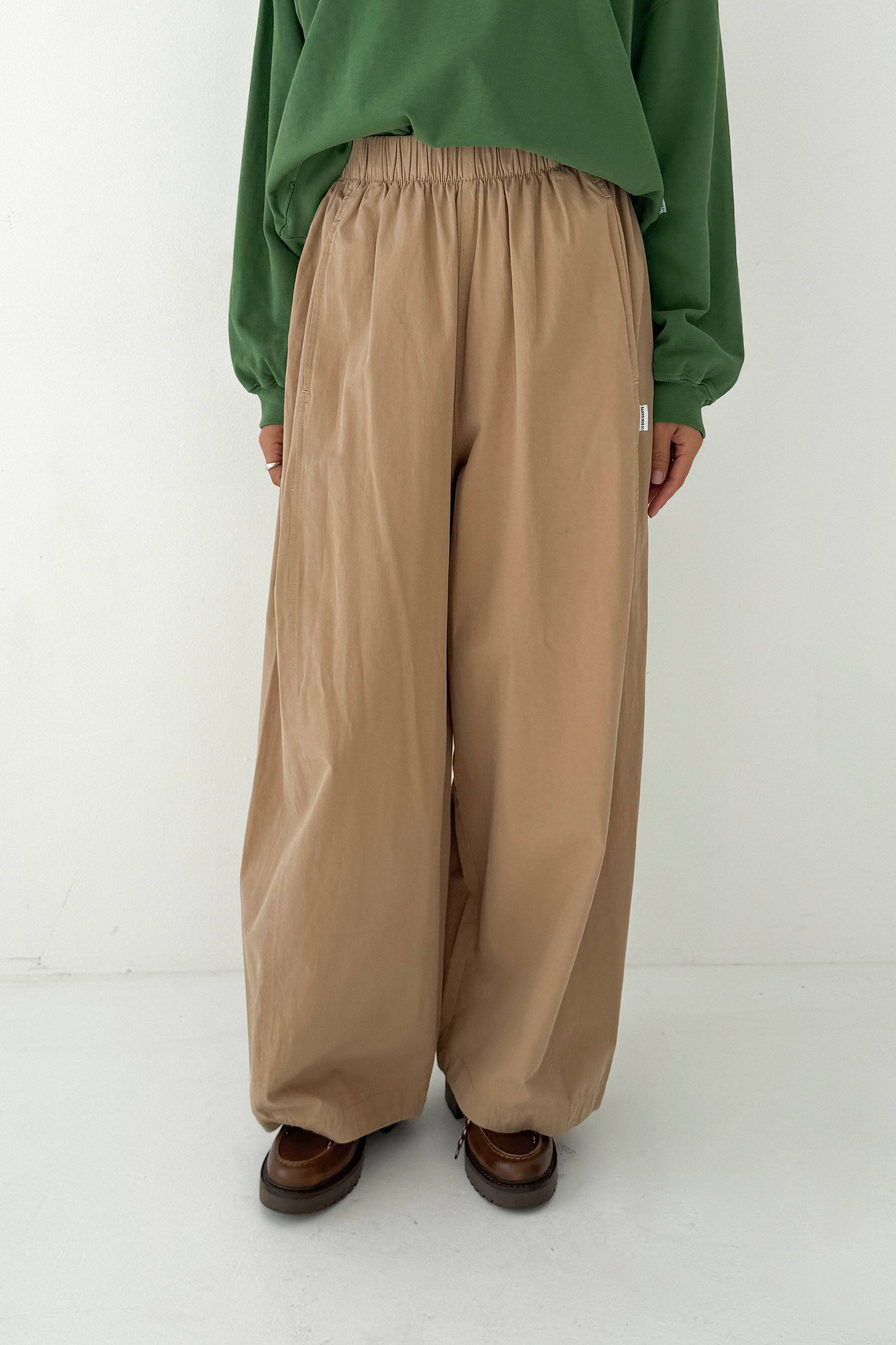 Woman wearing Spring fashion in a green sweatshirt and Le Bon Shoppe Khaki Cotton Parachute Pant at Alas Eius