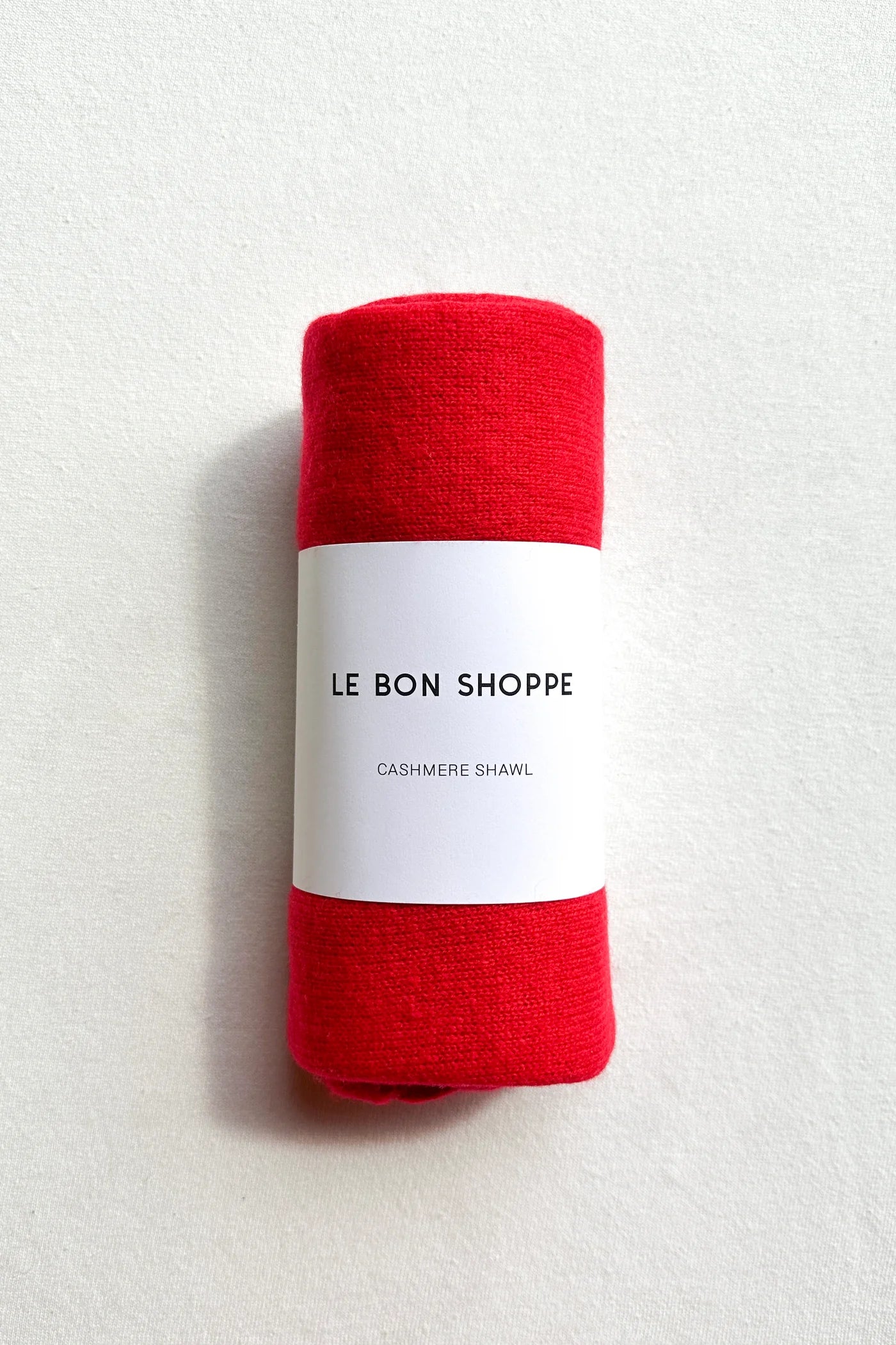 Le Bon Shoppe Red Cashmere Wool blend bandana Shawl rolled up in brand packaging at Alas Eius 