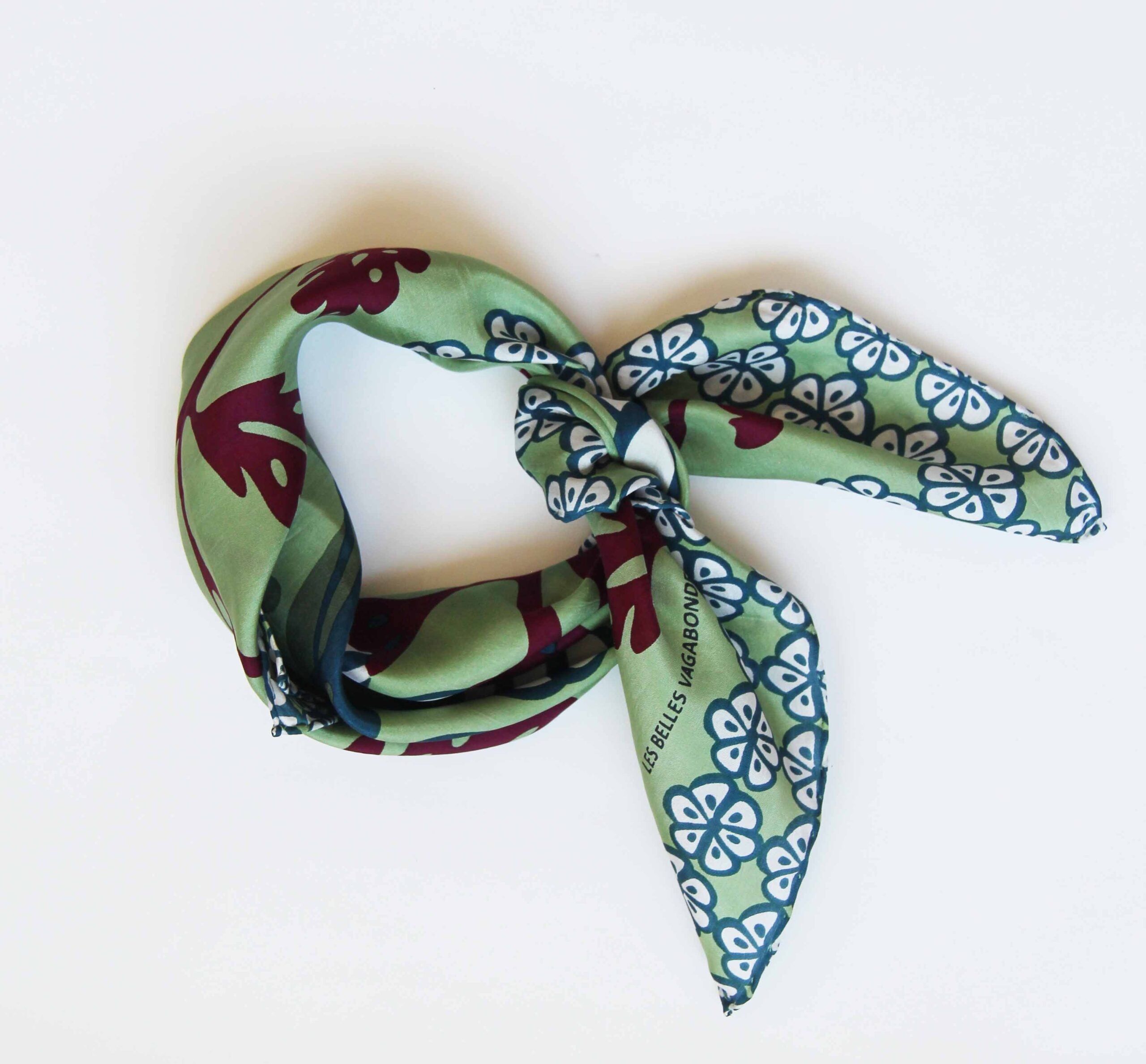 Product full view of a Les Belles Vagabones Alice Green hand drawn floral and mushroom print silk scarf at Alas Eius. 