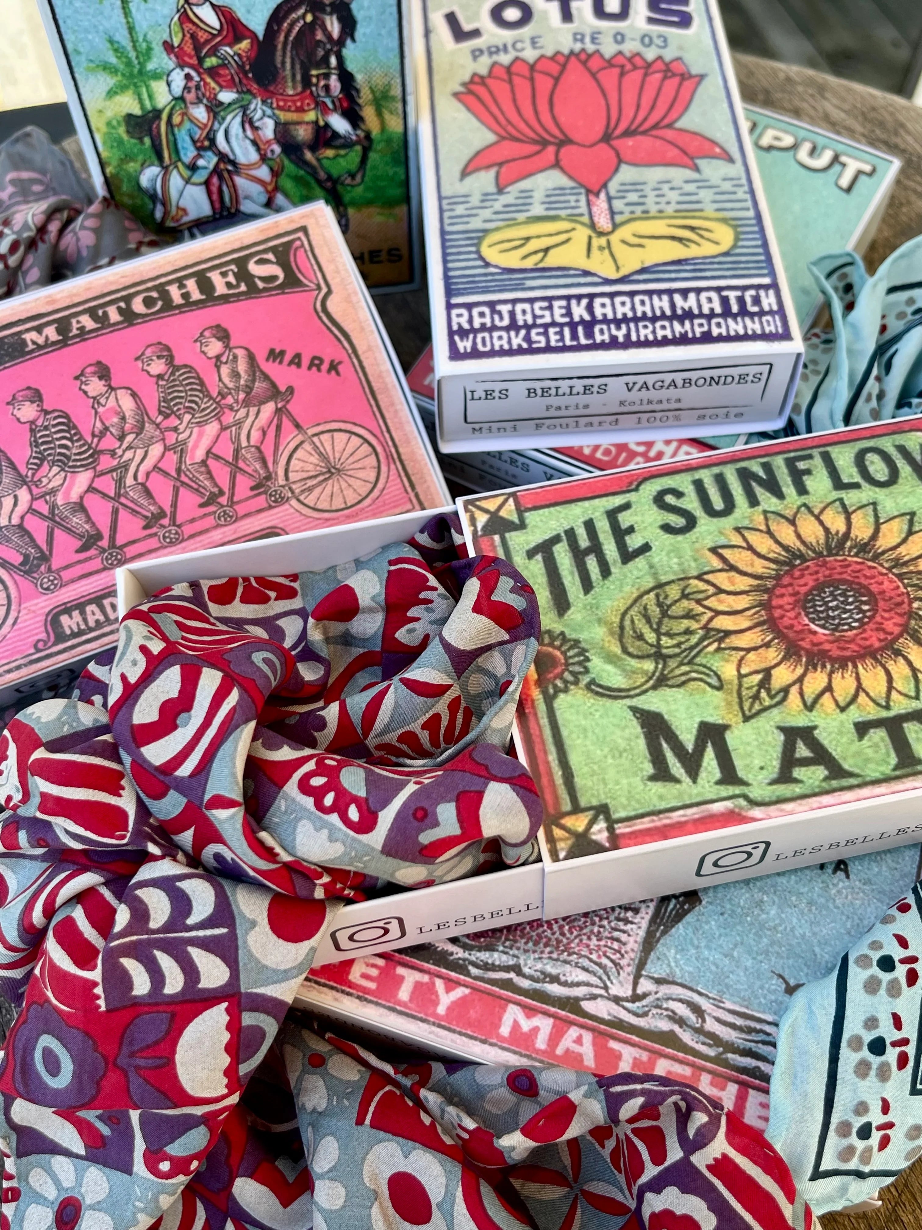 Matchbox style product boxes containing hand drawn printed silk scarf at Alas Eius. 
