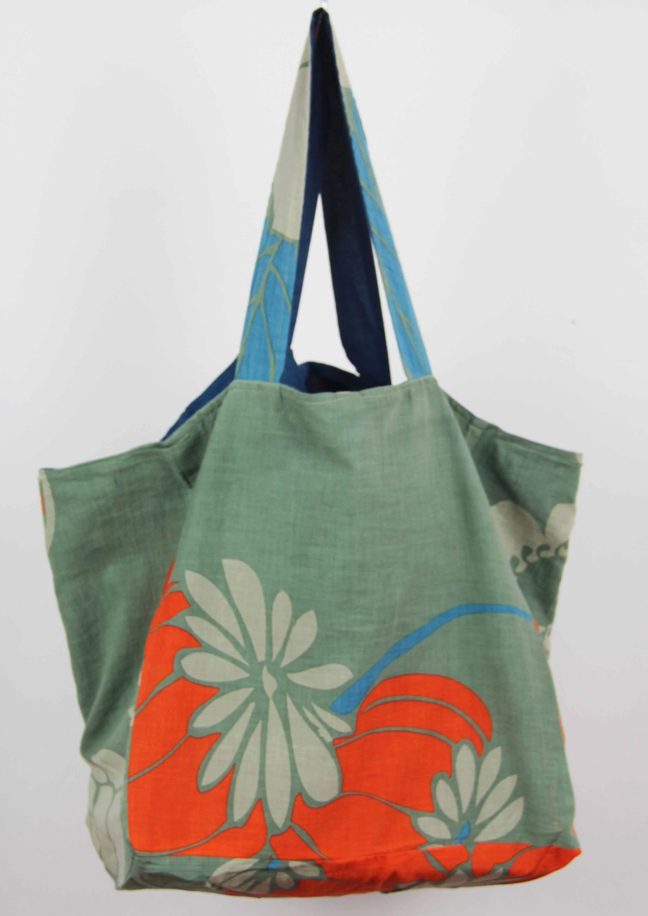 Full product view of the reversible Les Belles Vagabondes Orange And Khaki Poppy Organic Cotton Tote Bag at Alas Eius.