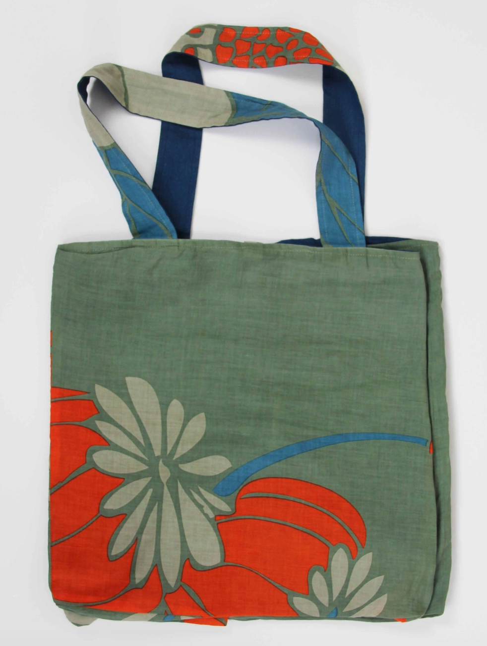 Full product view of the reversible Les Belles Vagabondes Orange And Khaki Poppy Organic Cotton Tote Bag at Alas Eius.