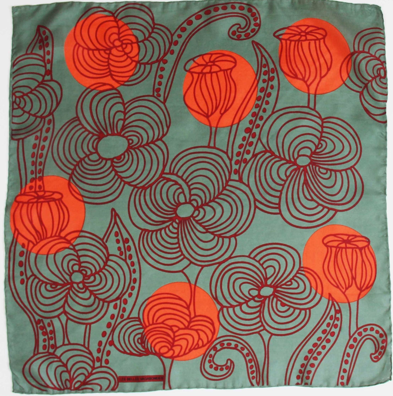 Close-up product view of hand drawn design on a Les Belles Vagabondes brand mini Khaki Green with Orange and Maroon Floral print Silk Scarf at Alas Eius. 