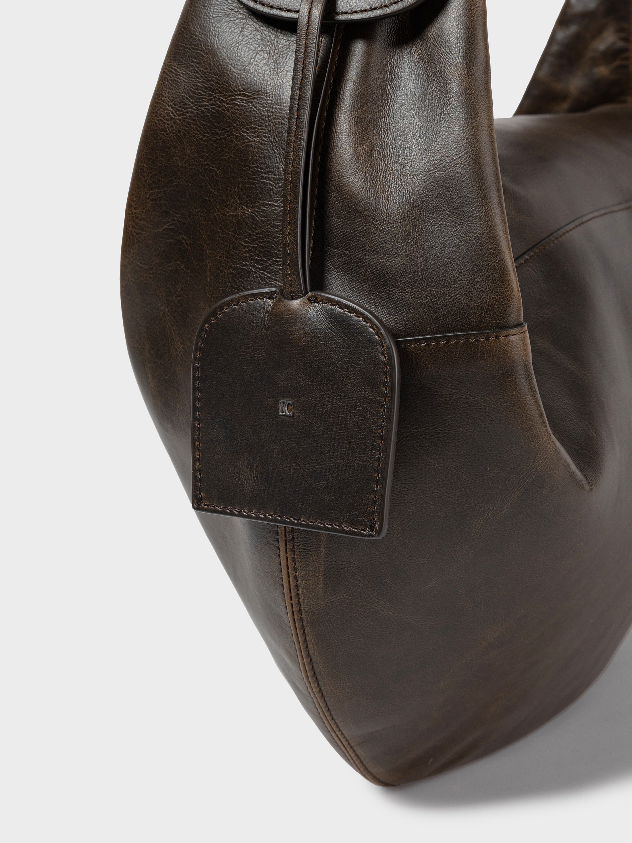 Close-up side view of Low Classic Brown Leather Cocoon Double Zip Crossbody Bag at Alas Eius