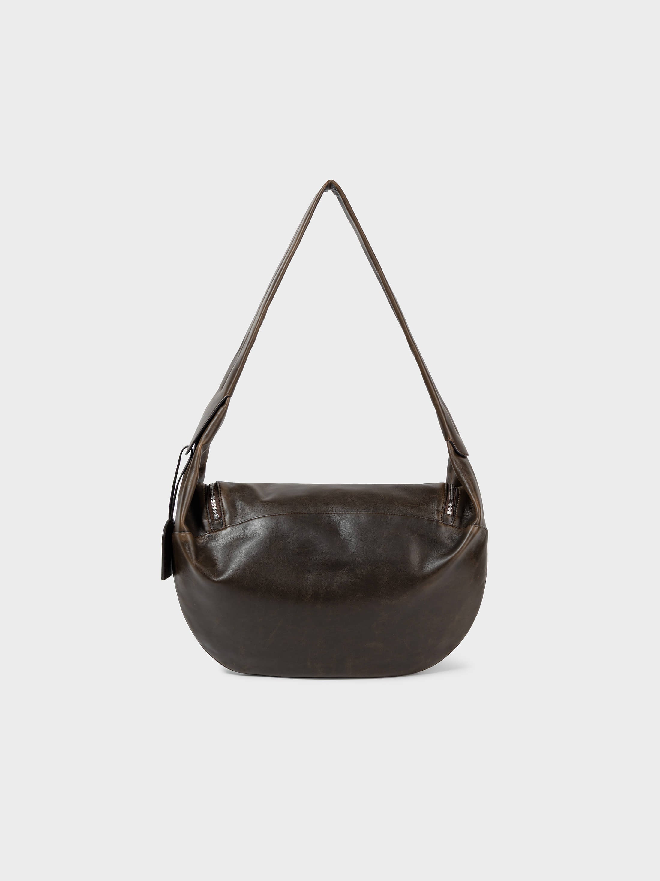 Back view of a Low Classic Brown Leather Cocoon Double Zip Crossbody Bag at Alas Eius
