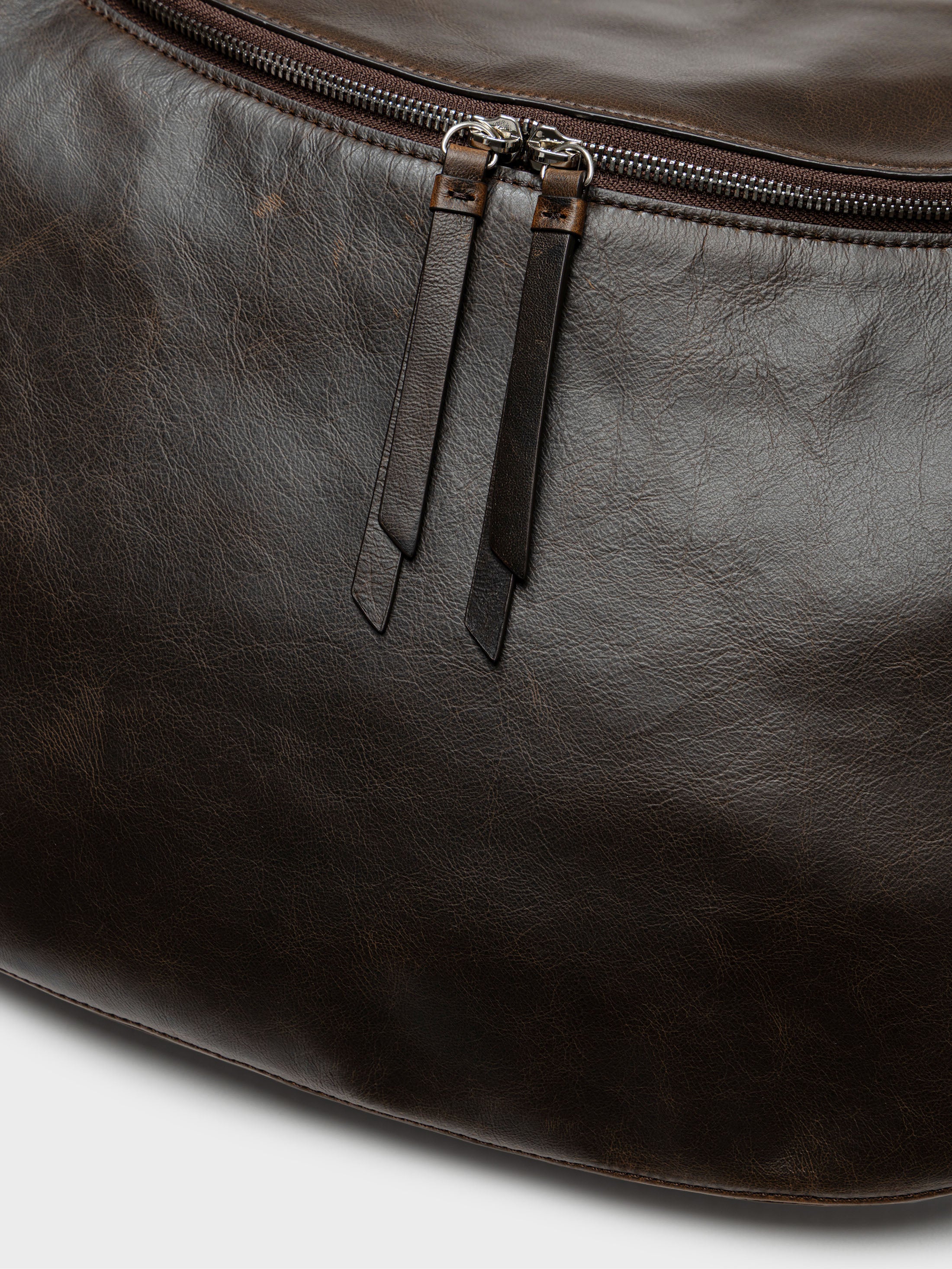 Close-up detailed view of the zipper on a Low Classic Brown Leather Cocoon Double Zip Crossbody Bag at Alas Eius