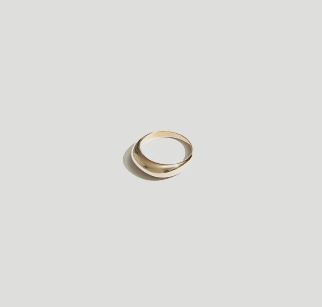 Product view of a minimalist contemporary jewelry in a Maslo 14k gold plated dome ring at Alas Eius. 