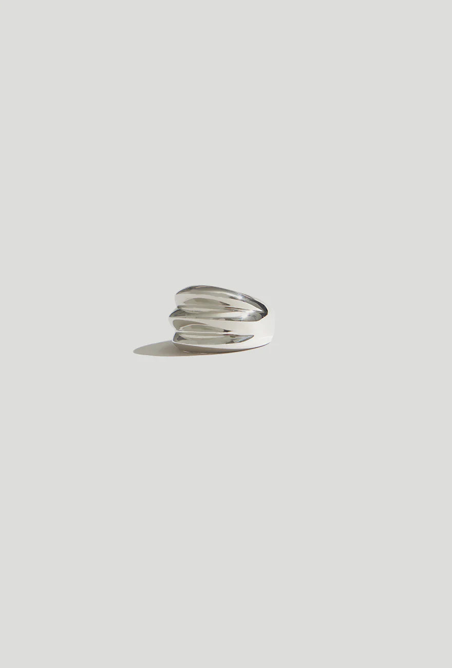 Product view of contemporary jewelry in a Maslo triple sterling silver ring at Alas Eius. 