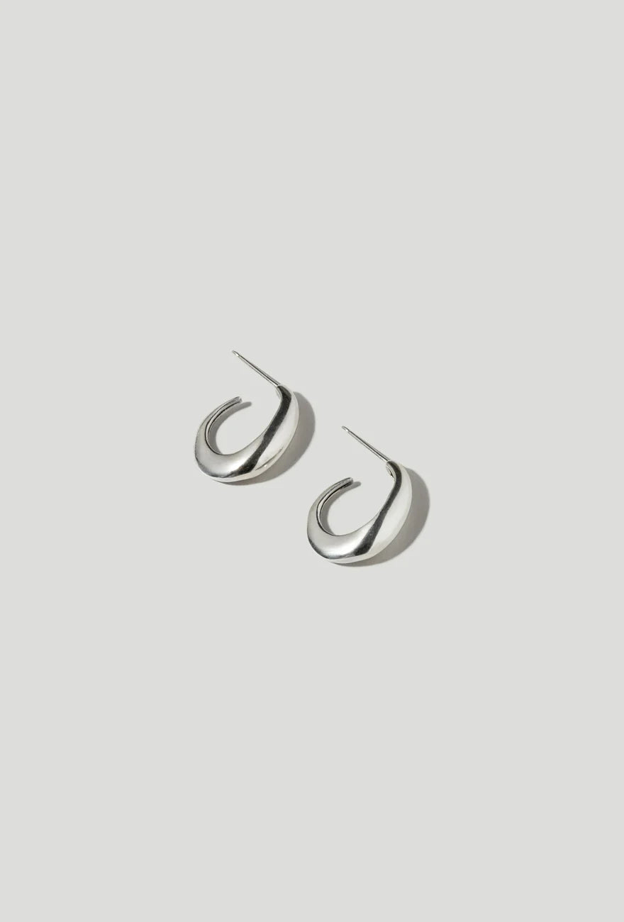 Product view of minimalist jewelry in a pair of Maslo Ceres sterling silver thick hoop stud earrings at Alas Eius.