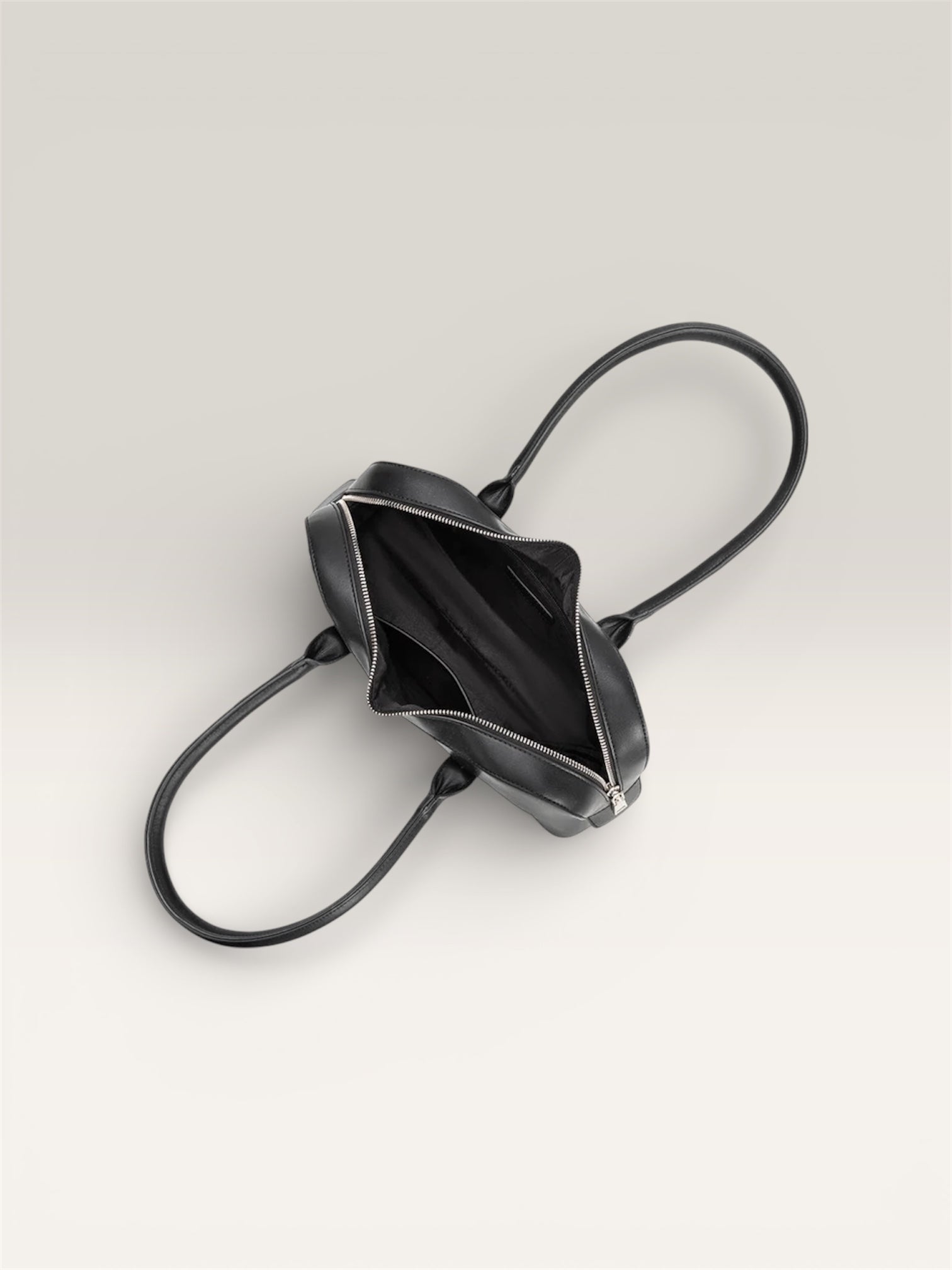 Aerial view of the sleek and modern Melie Bianco Tilda Large Black Vegan Leather Shoulder Bag open on a white background at Alas Eius 