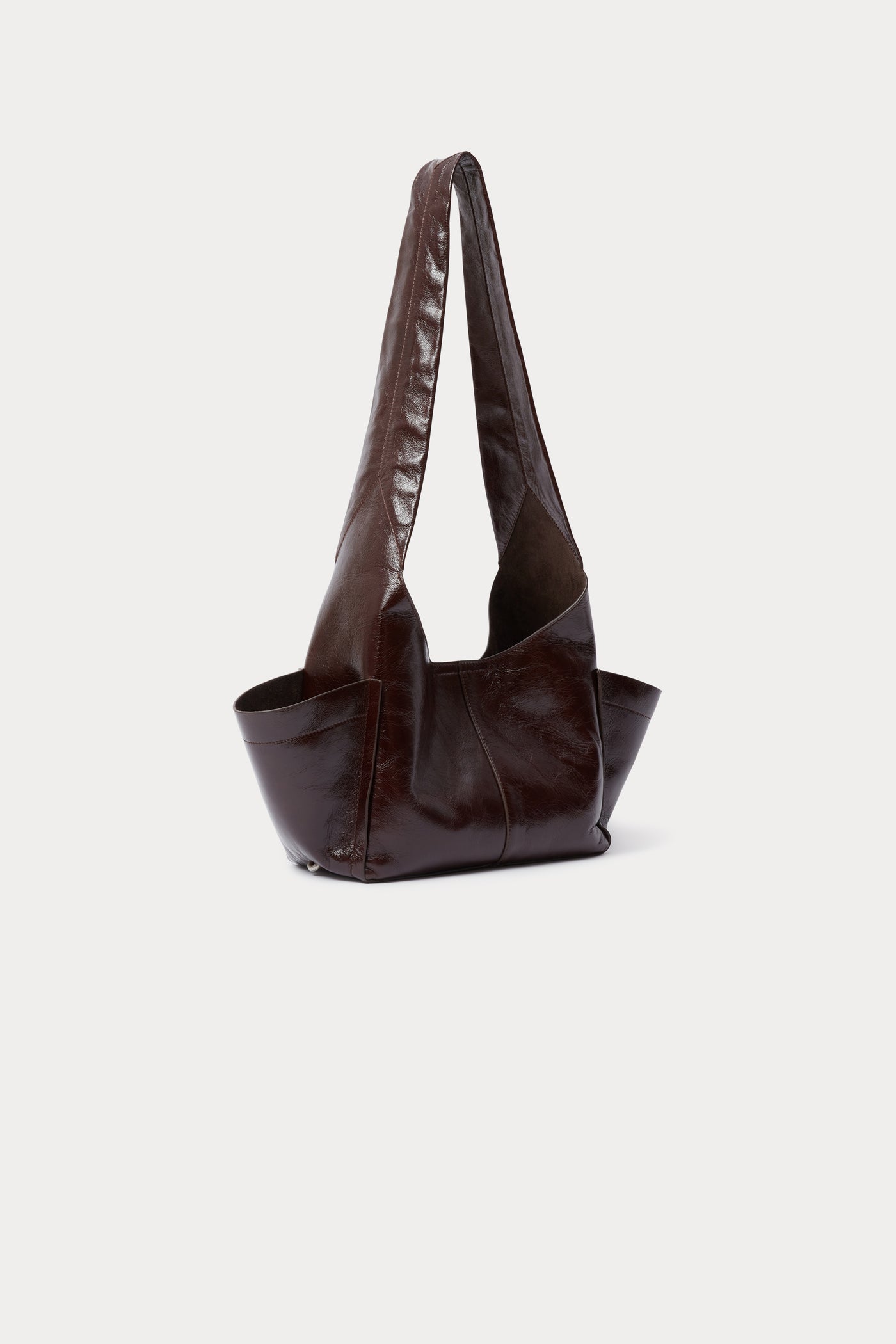 Modern minimalist Rachel Comey Chestnut Leather Tool Bag featuring a fixed shoulder strap, extended exterior pockets, and magnetic closure. Can be worn over the shoulder or across the body at an Alas Eius store. Made in Italy. 