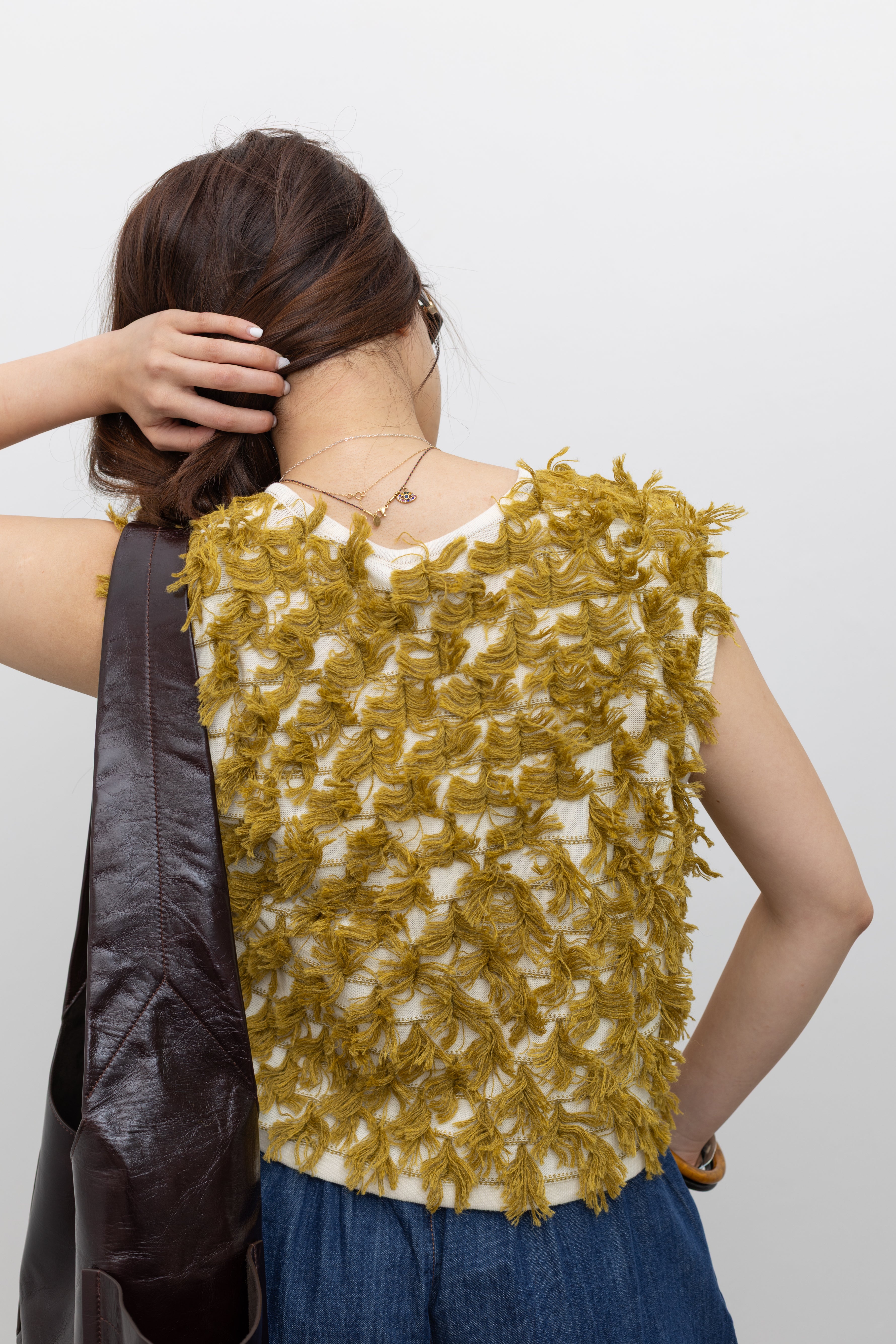 Rachel Comey minimal knit sleeveless top with playful fringe layers and an easy, boxy fit at Alas Eius. 